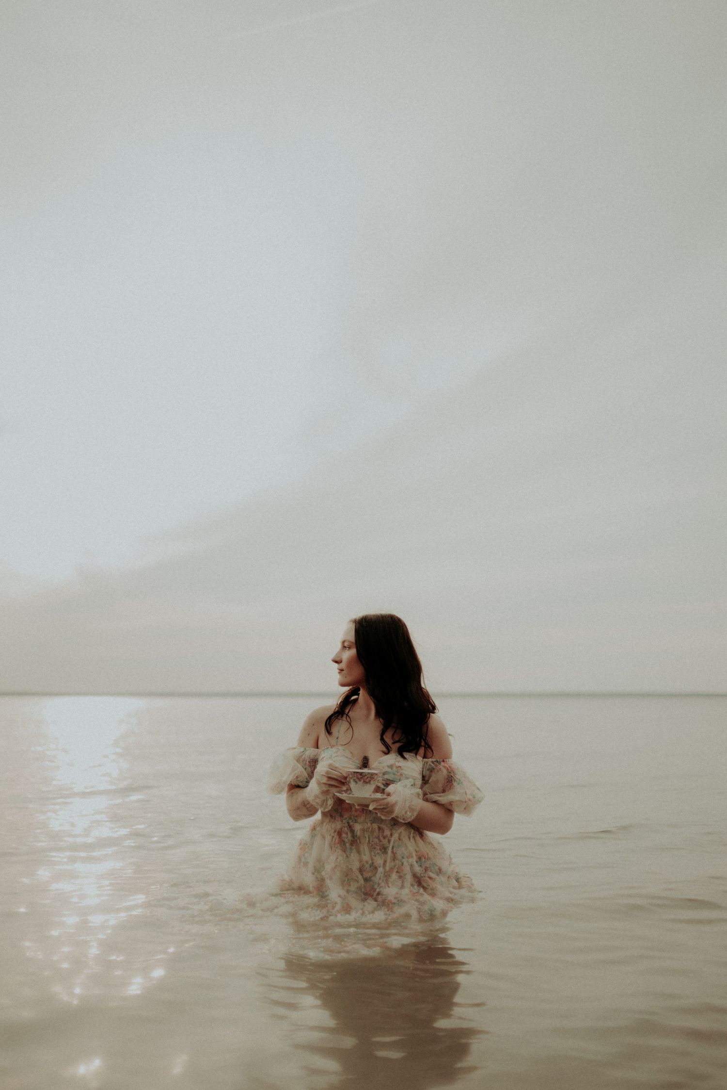 Minimalist water portrait series with soft lighting and delicate poses.