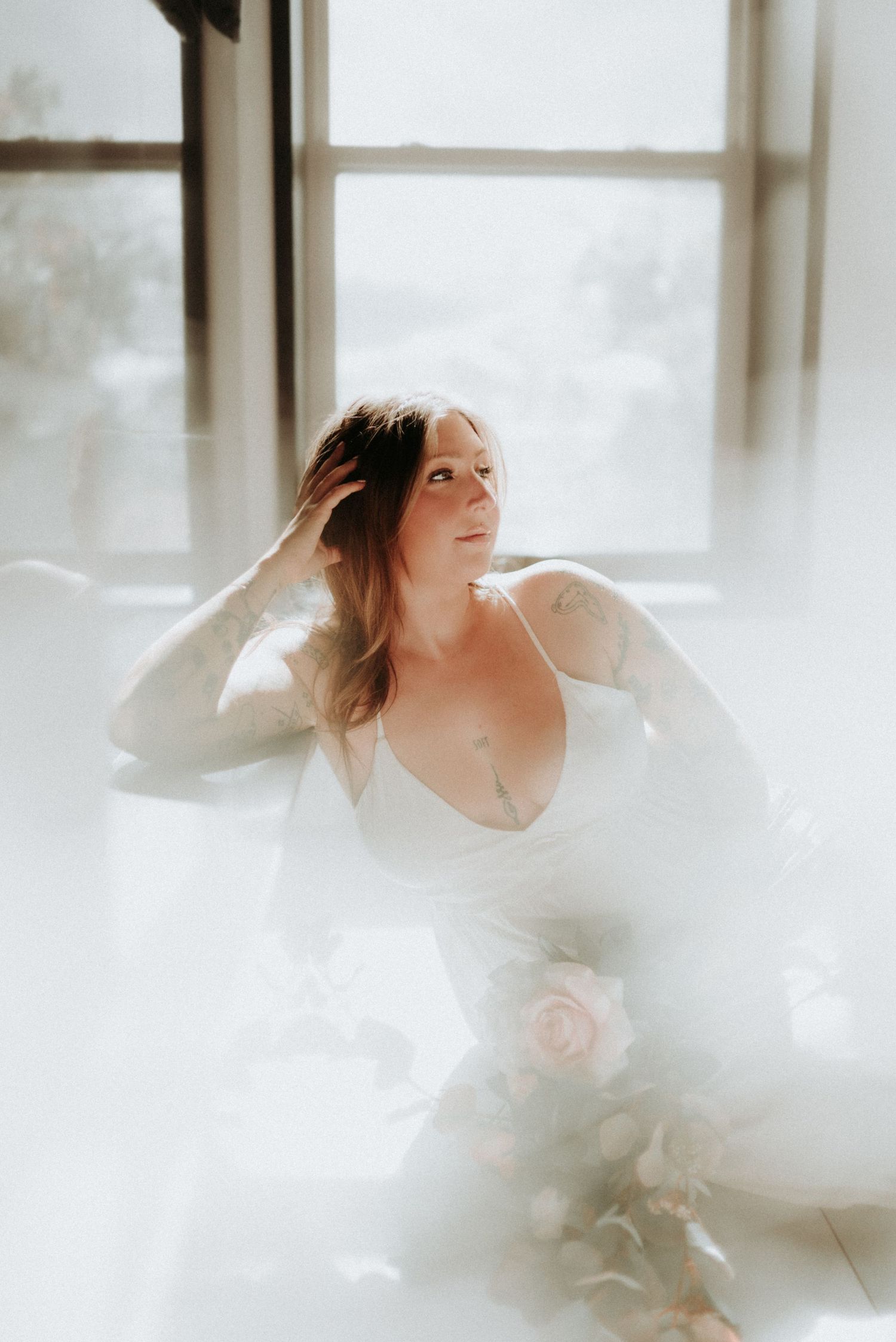 Graceful movement captured in a series of ethereal photos with flowing white fabric and natural window light.