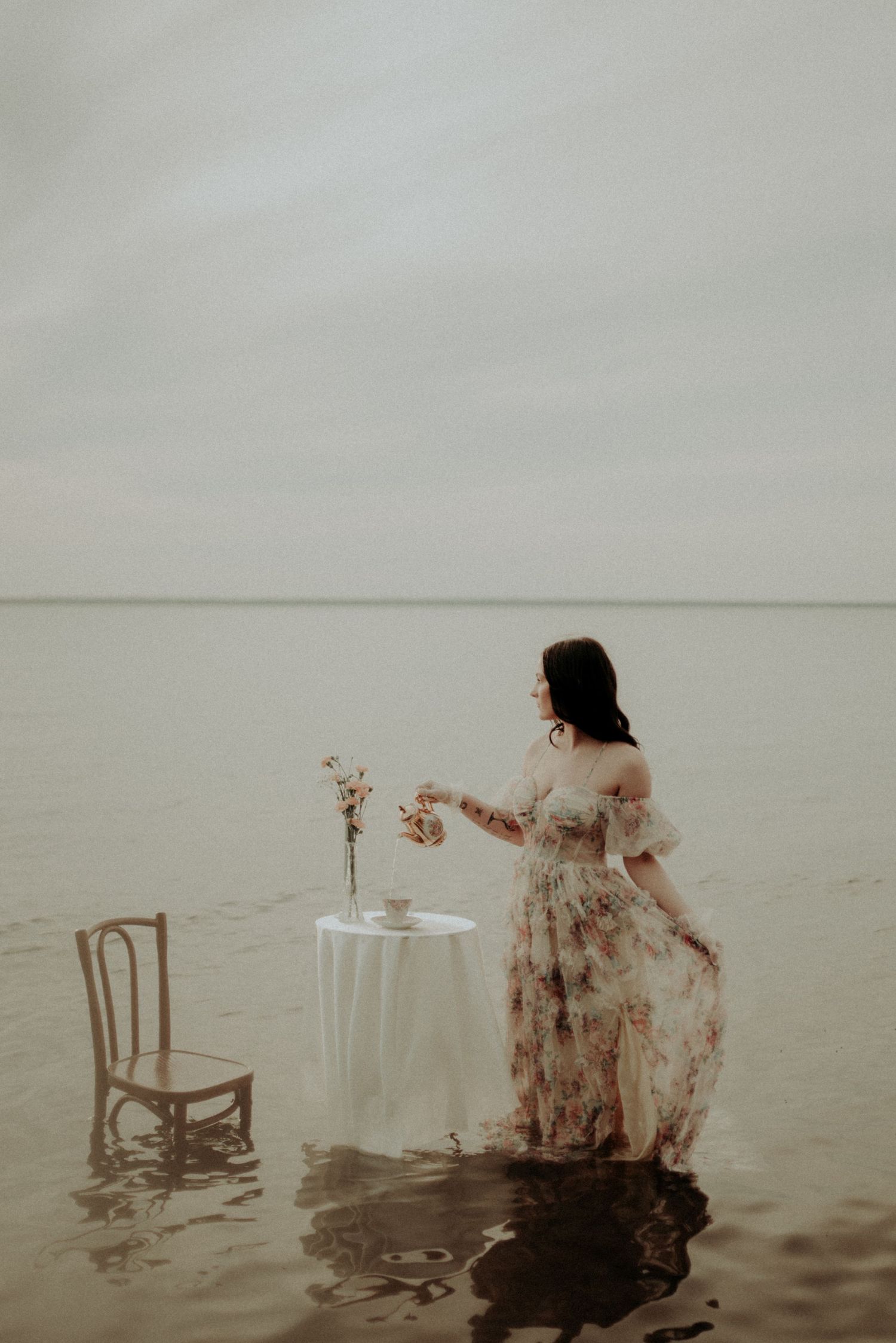 Moody water photography featuring submerged furniture and flowing fabric.