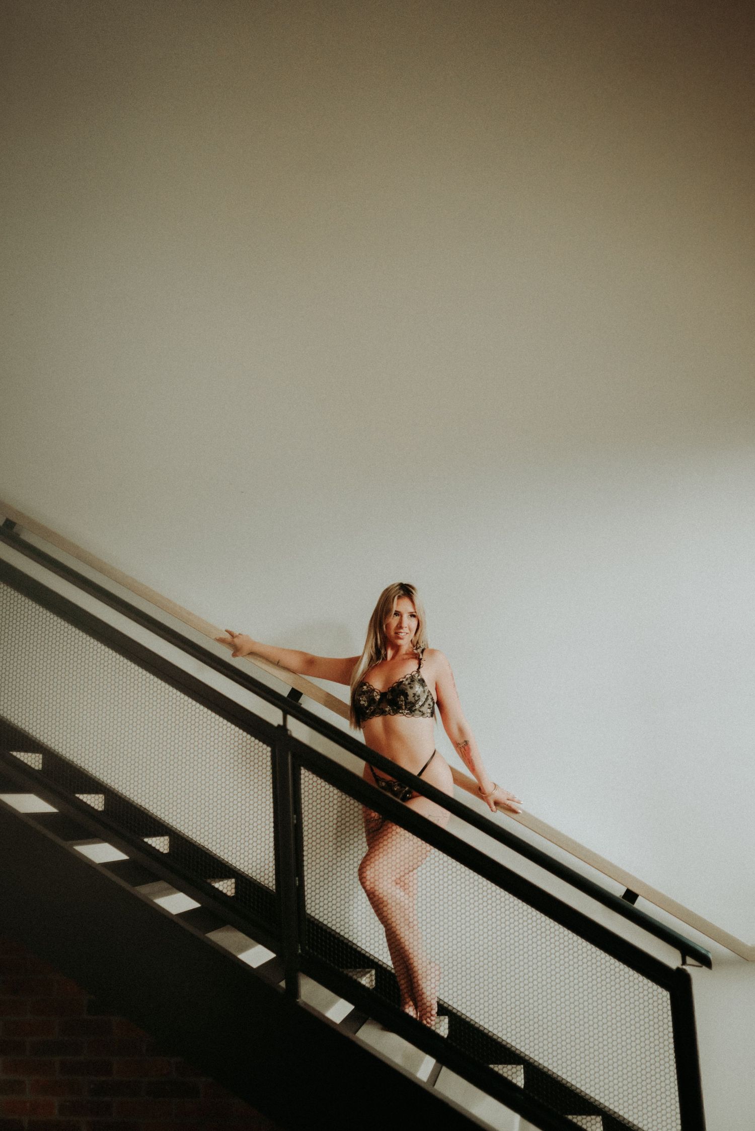 Artistic series showing figure ascending stairs in minimalist setting with natural light.