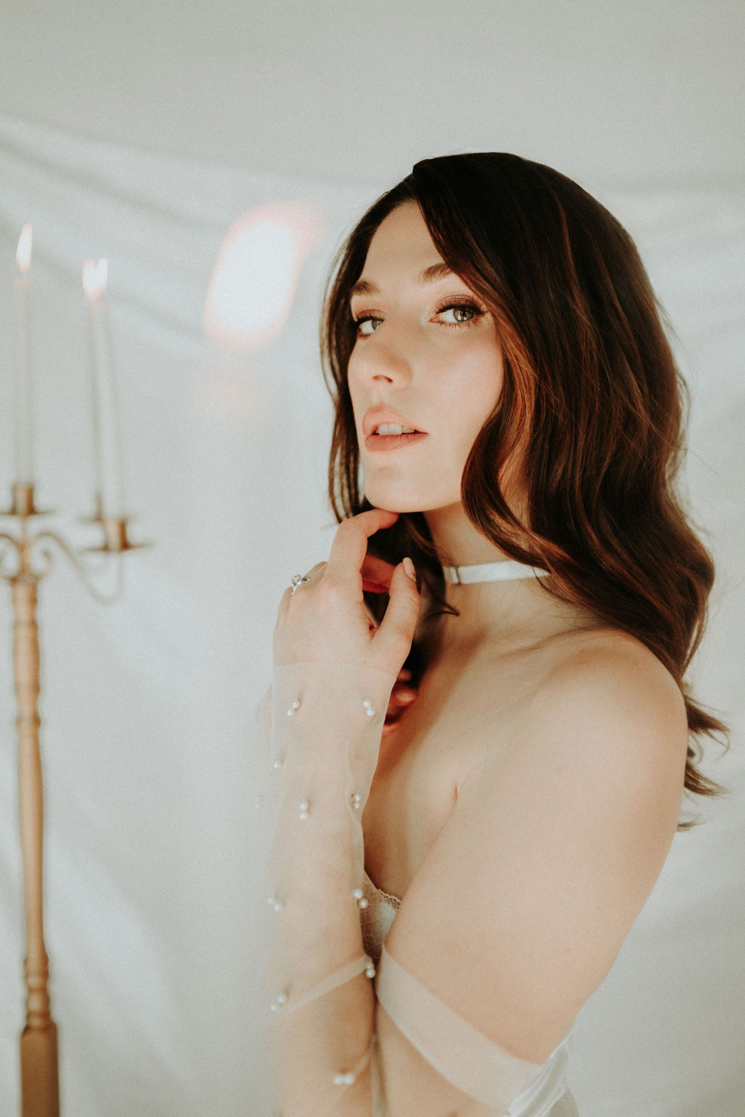Artistic portrait series against white backdrop with soft lighting and romantic ethereal mood.