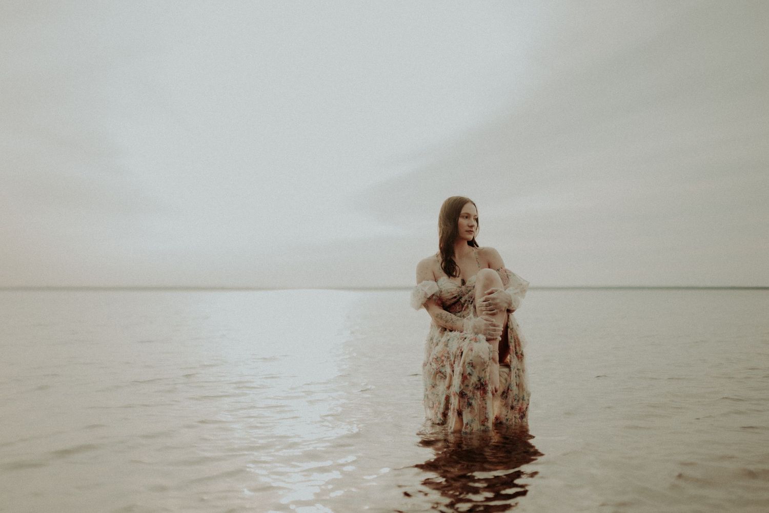 Dreamlike water photography featuring vintage furniture and flowing fabric.