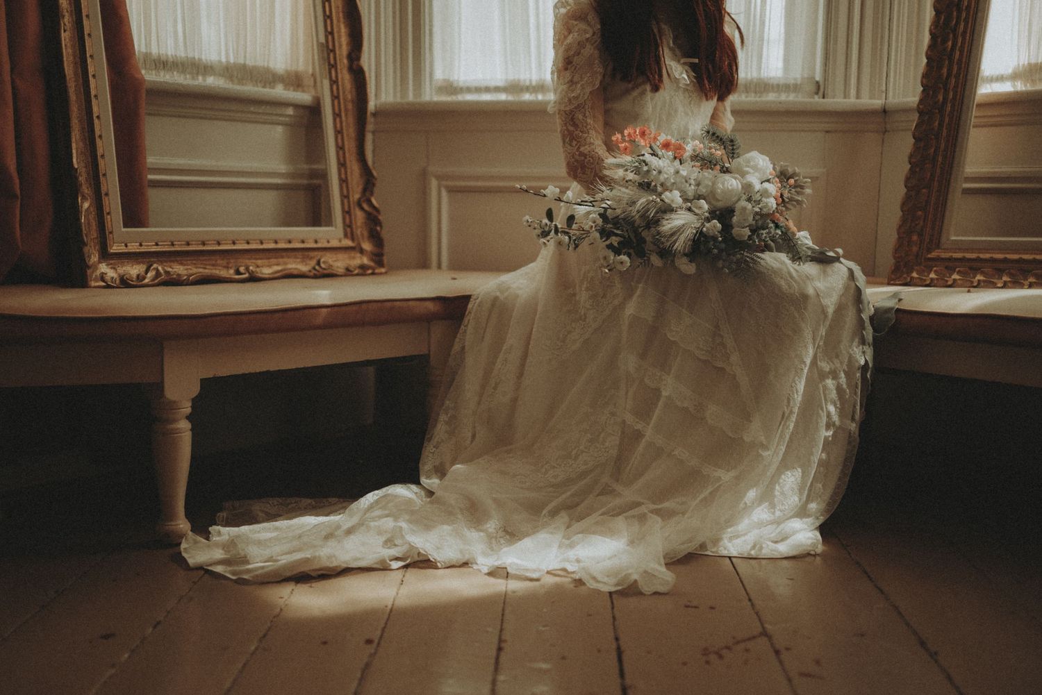 Multiple views of a bridal gown captured against warm window light and ornate gold picture frames.