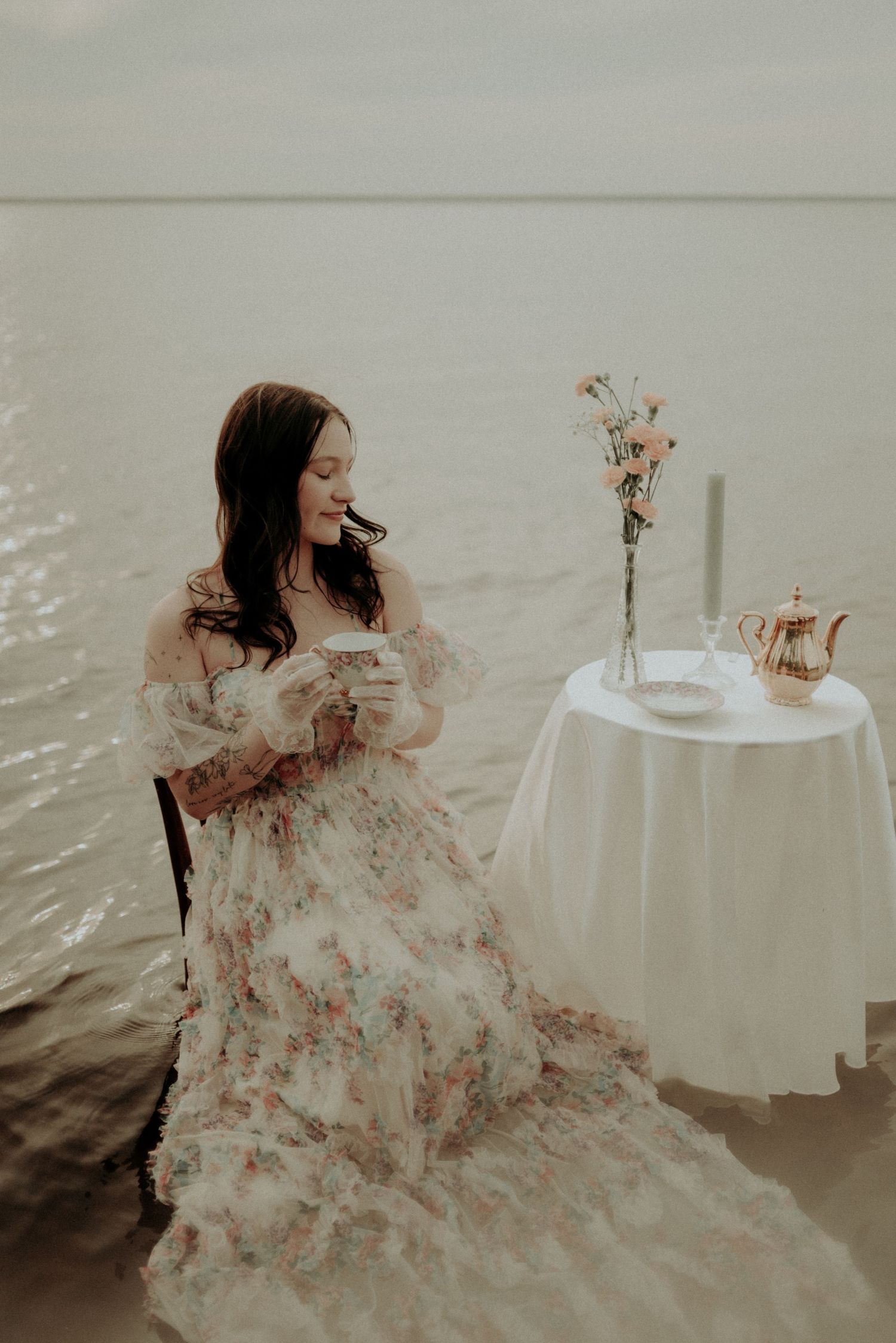 Ethereal water photography featuring floral dress and elegant table setting in muted tones.