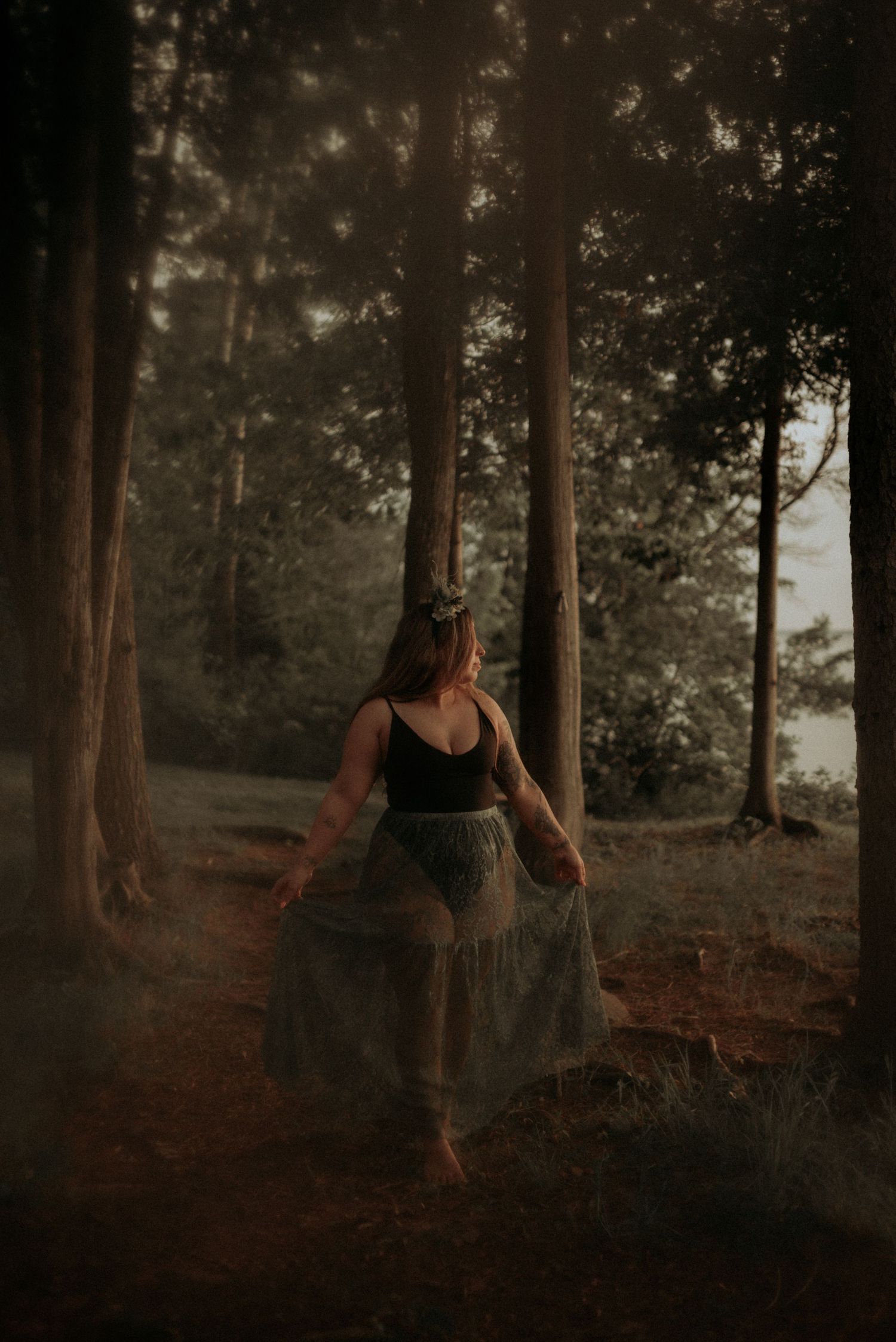 Whimsical forest dance captured in warm sepia tones among tall trees.