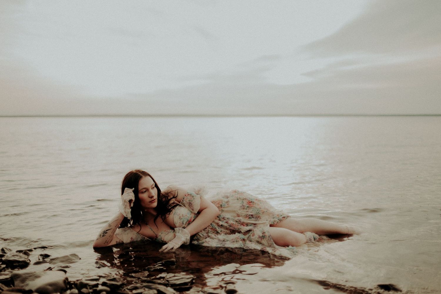 Dreamy water photography featuring a vintage dress and natural shoreline elements.