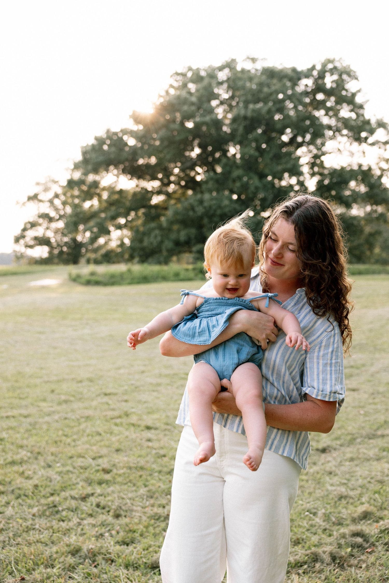 Virginia Beach Family Photographer photographs babies first birthday in beautiful field setting.