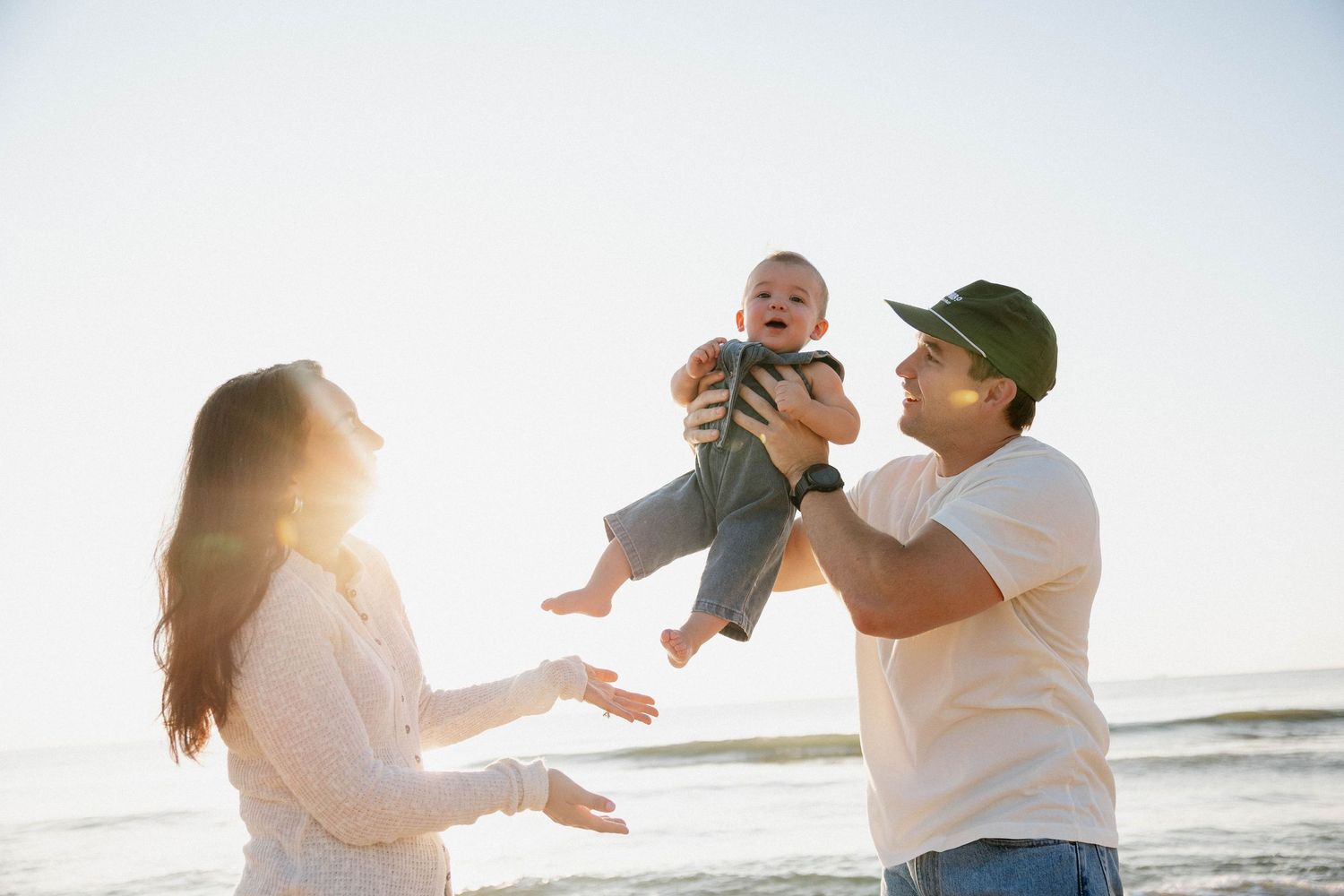 Virginia Beach family photographer photographs family at sunrise in Virginia Beach.