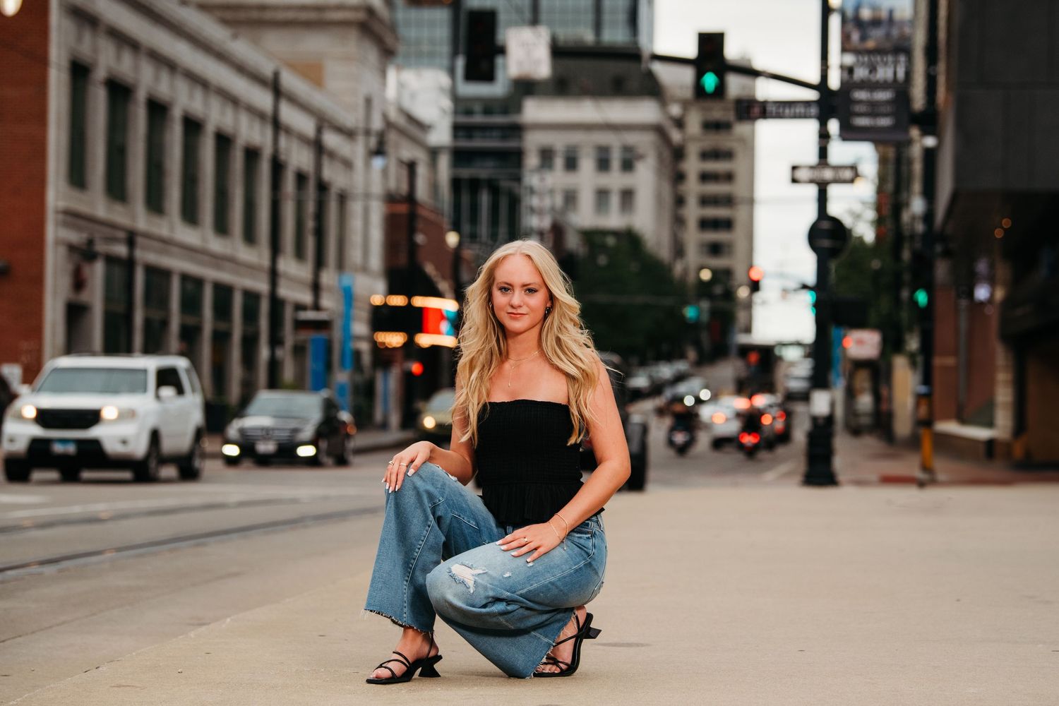 Urban fashion shoot on city street with model in casual denim outfit.