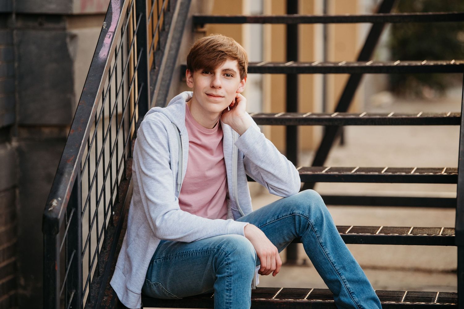 Outdoor portraits on brick steps with casual denim and layered outfit styling.