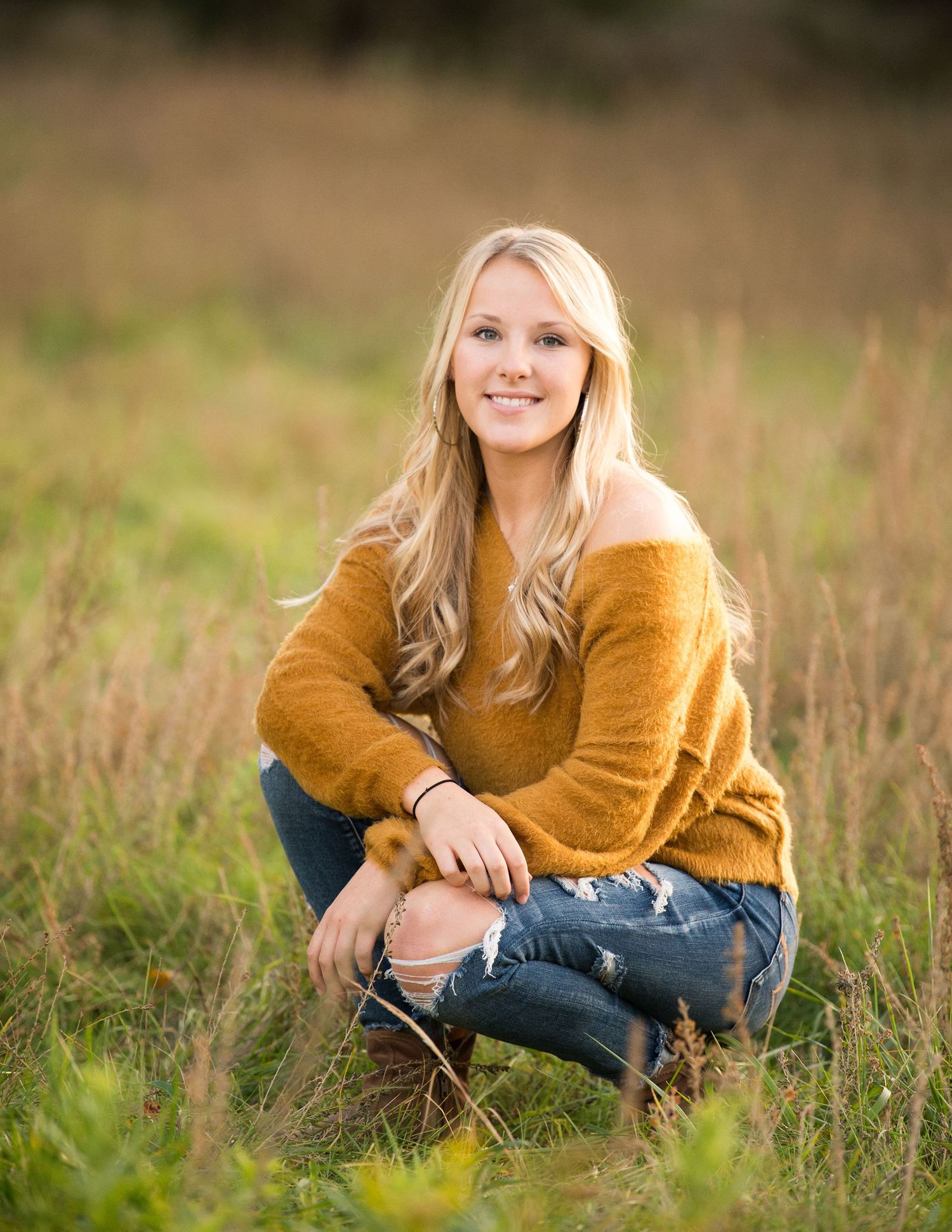 Portrait session in a golden field with casual autumn styling.