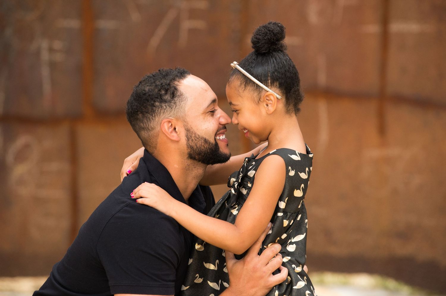 A couple shares a romantic moment in a rustic wooden setting with warm lighting.