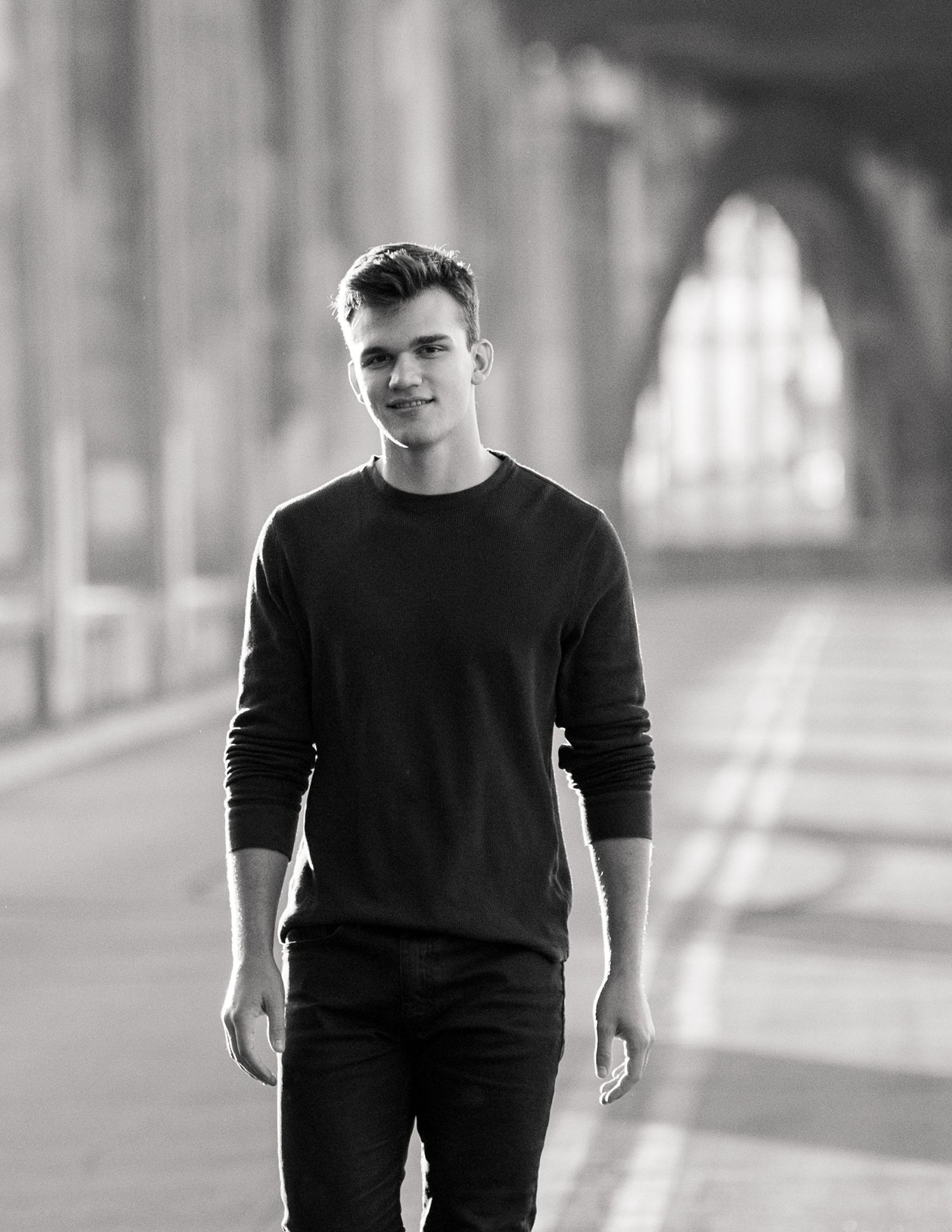Black and white portrait photography series in an urban architectural setting.