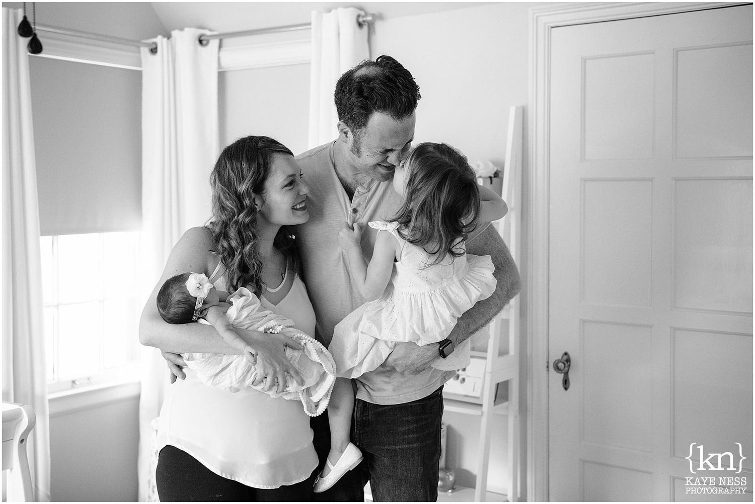 Black and white intimate family photos showing tender moments between parents and baby.