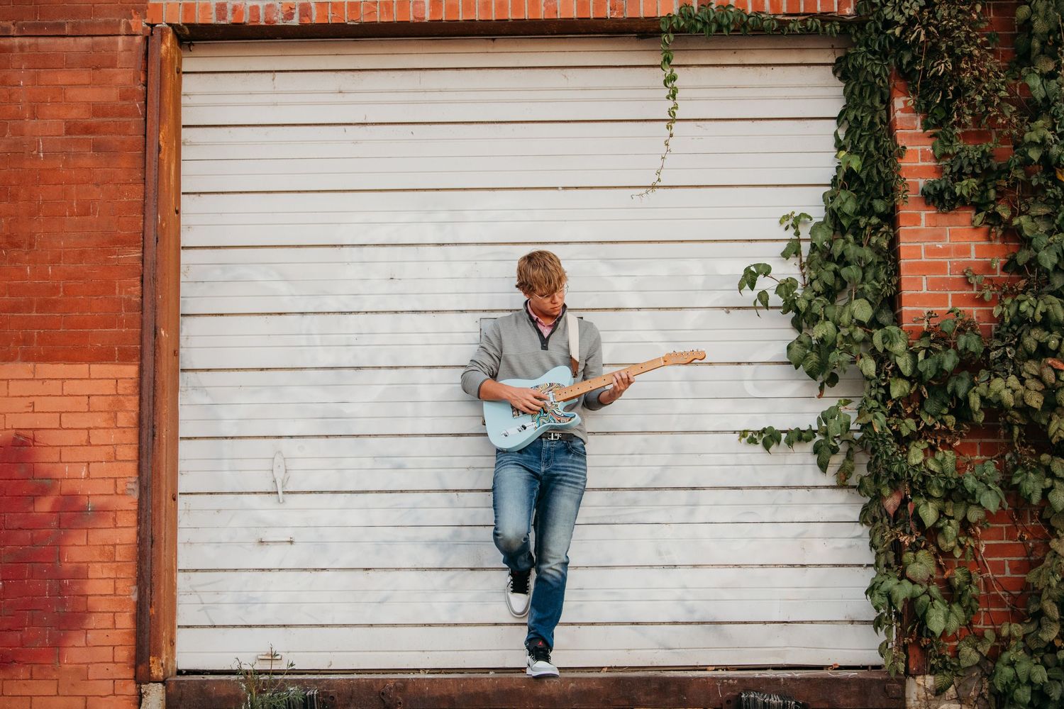Lifestyle portraits against white wooden wall and brick background.