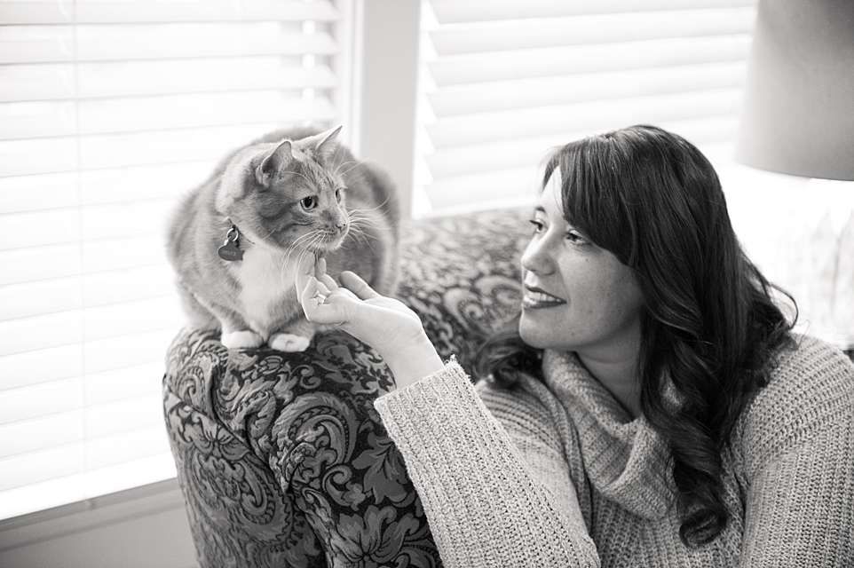 A black and white photo series showing tender moments between a person and their cat in a cozy home setting.