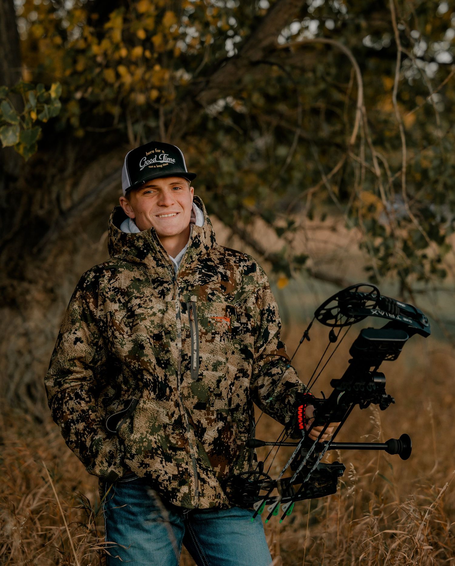 High school senior boy on family farm near Willow Lake, South Dakota with tractor and hunting gear