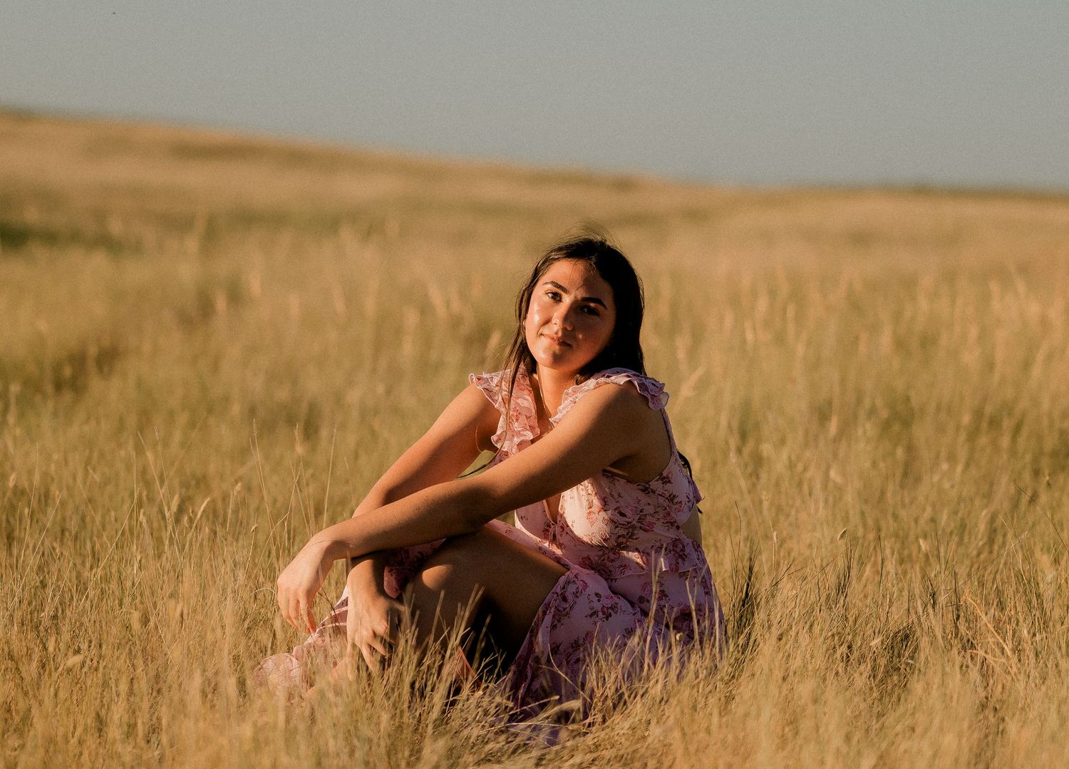 Outdoor senior portrait with soft natural light and relaxed pose
