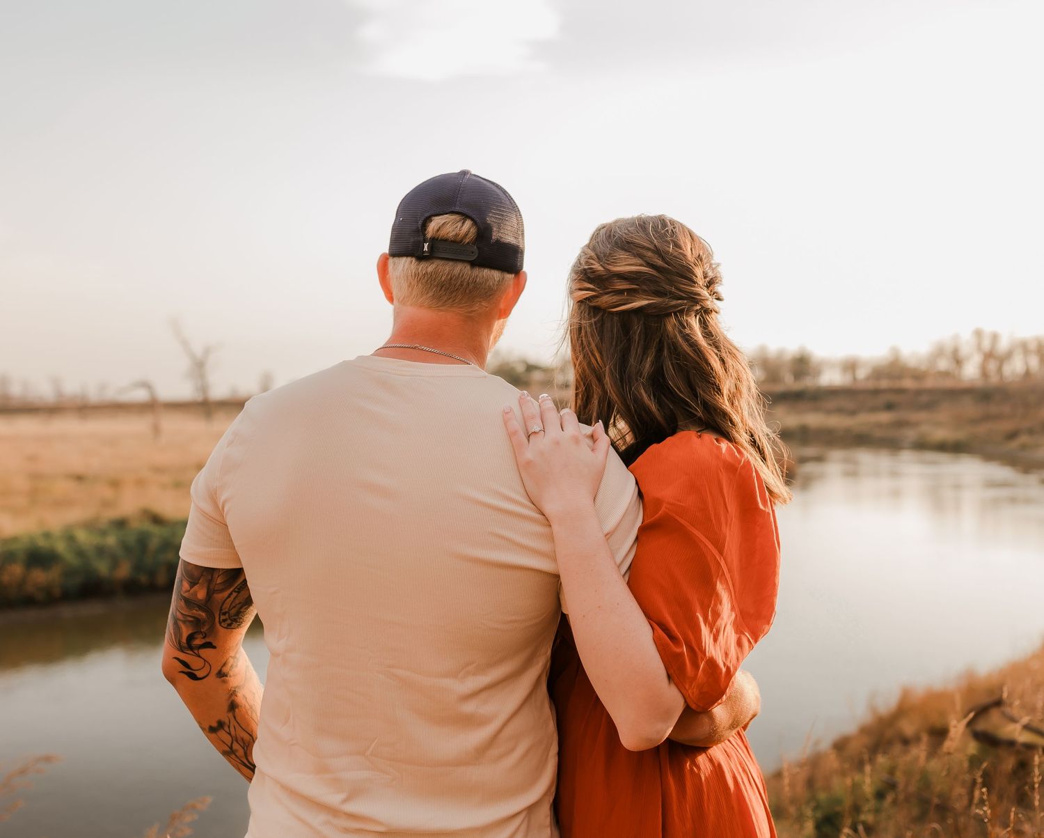 Engaged couple during fall photo session near Redfield, South Dakota with bride in red dress