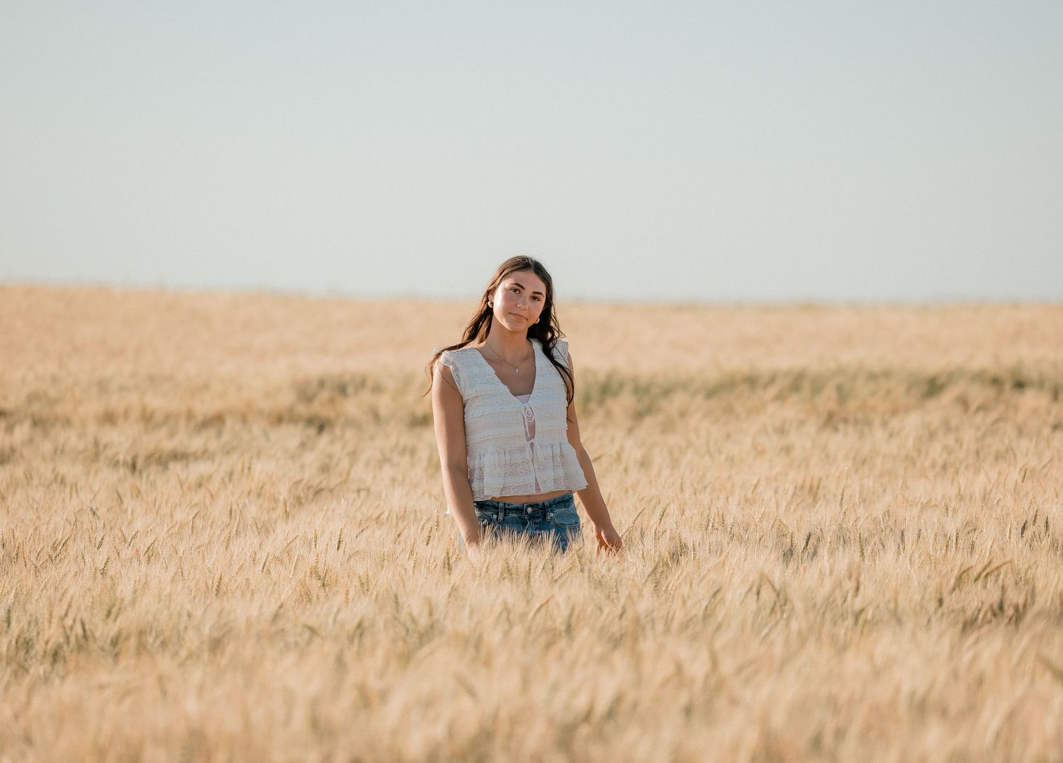 Outdoor senior portrait with soft natural light and relaxed pose
