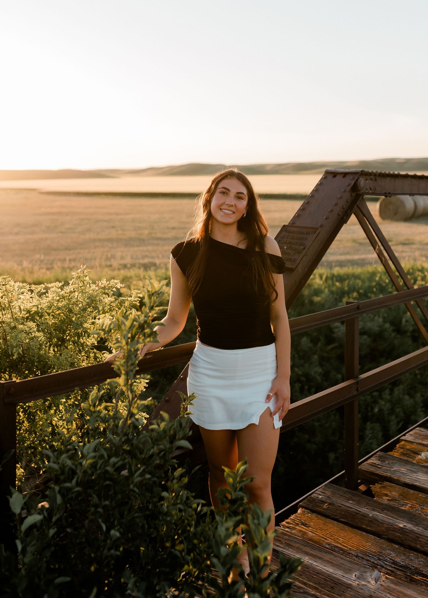 Outdoor senior portrait with soft natural light and relaxed pose