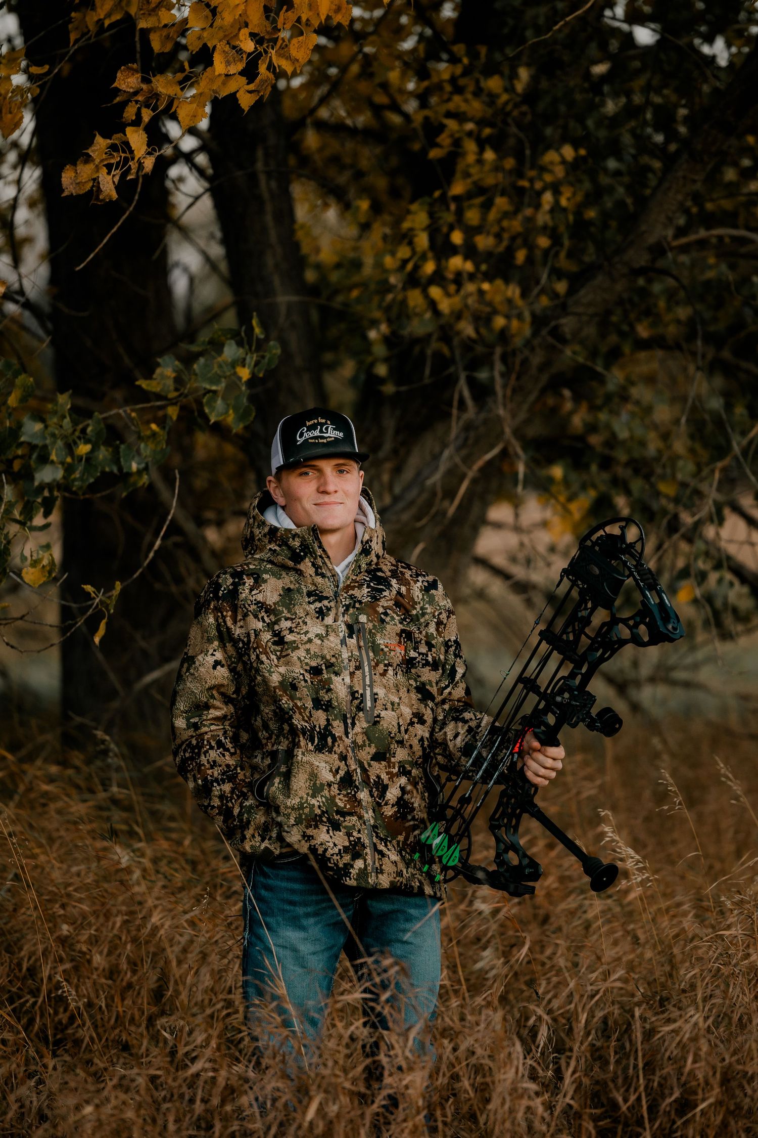 High school senior boy on family farm near Willow Lake, South Dakota with tractor and hunting gear