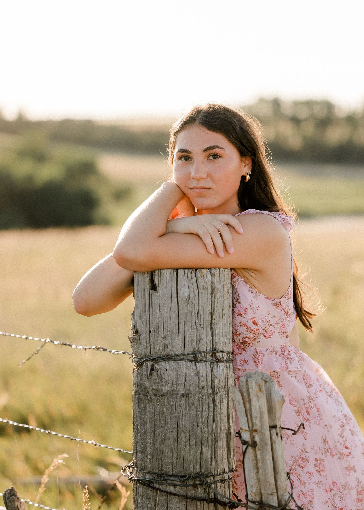 Outdoor senior portrait with soft natural light and relaxed pose