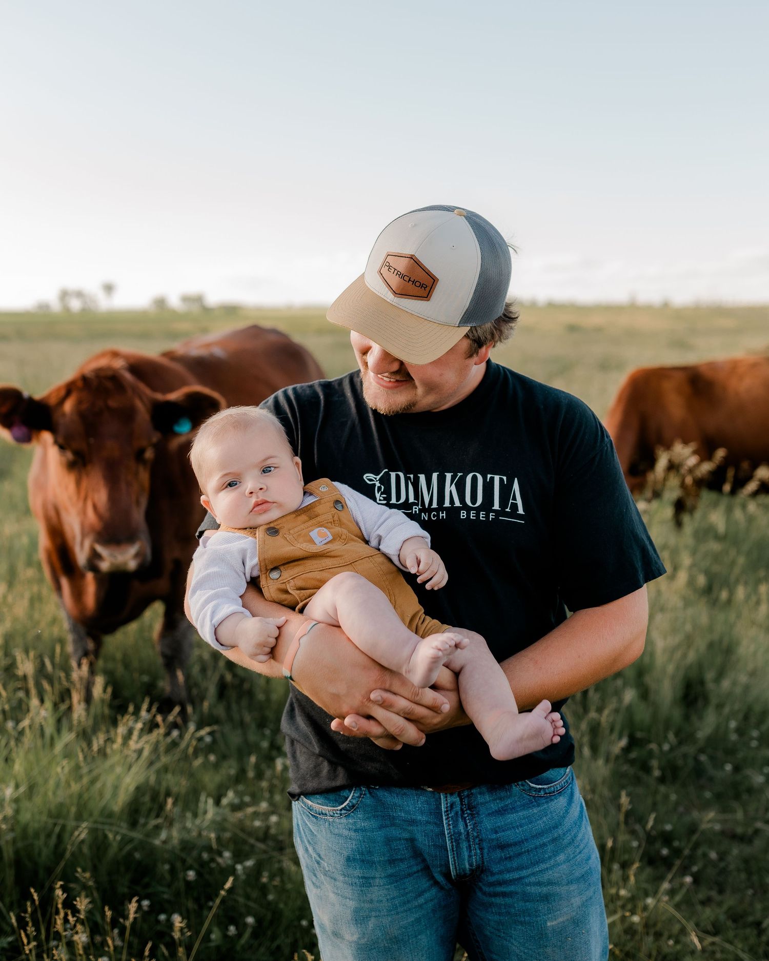 Family portrait on a working farm during lifestyle photo session in Clark County, South Dakota