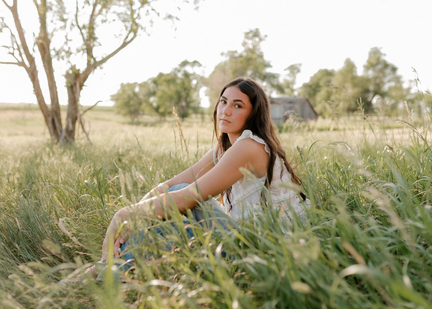 Outdoor senior portrait with soft natural light and relaxed pose