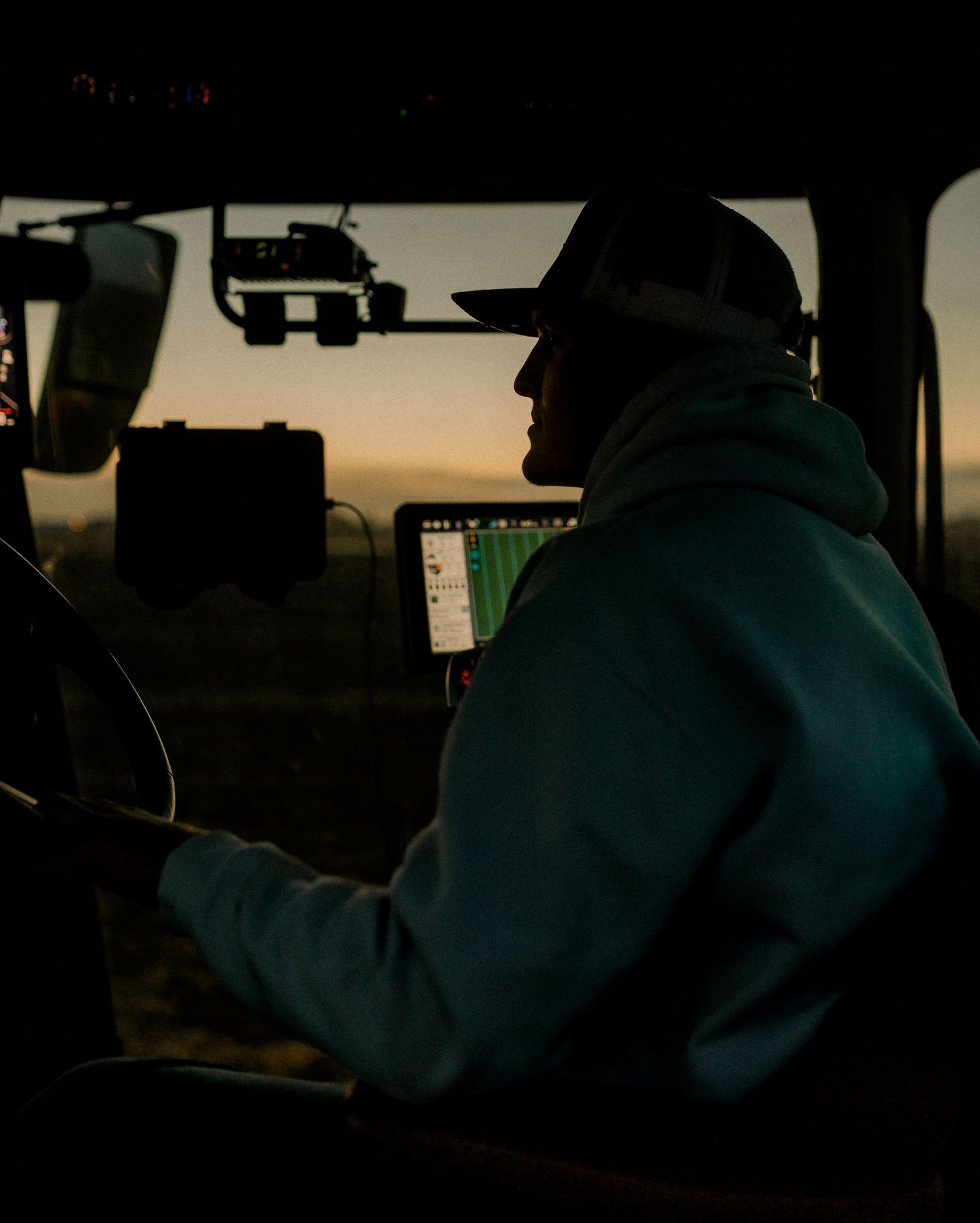 High school senior boy on family farm near Willow Lake, South Dakota with tractor and hunting gear