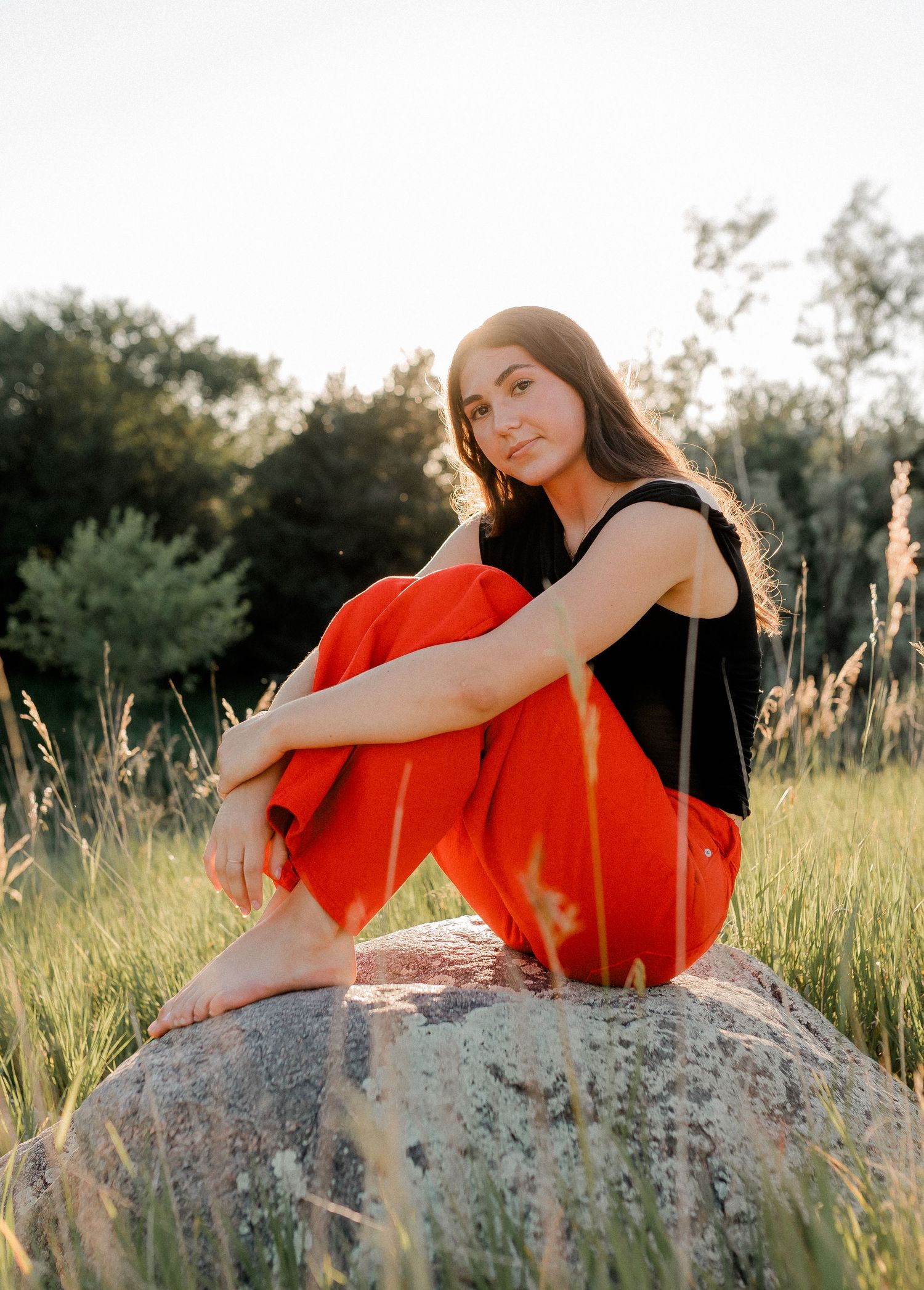 Outdoor senior portrait with soft natural light and relaxed pose