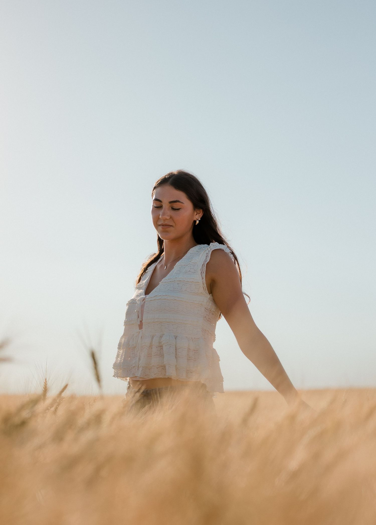 Outdoor senior portrait with soft natural light and relaxed pose