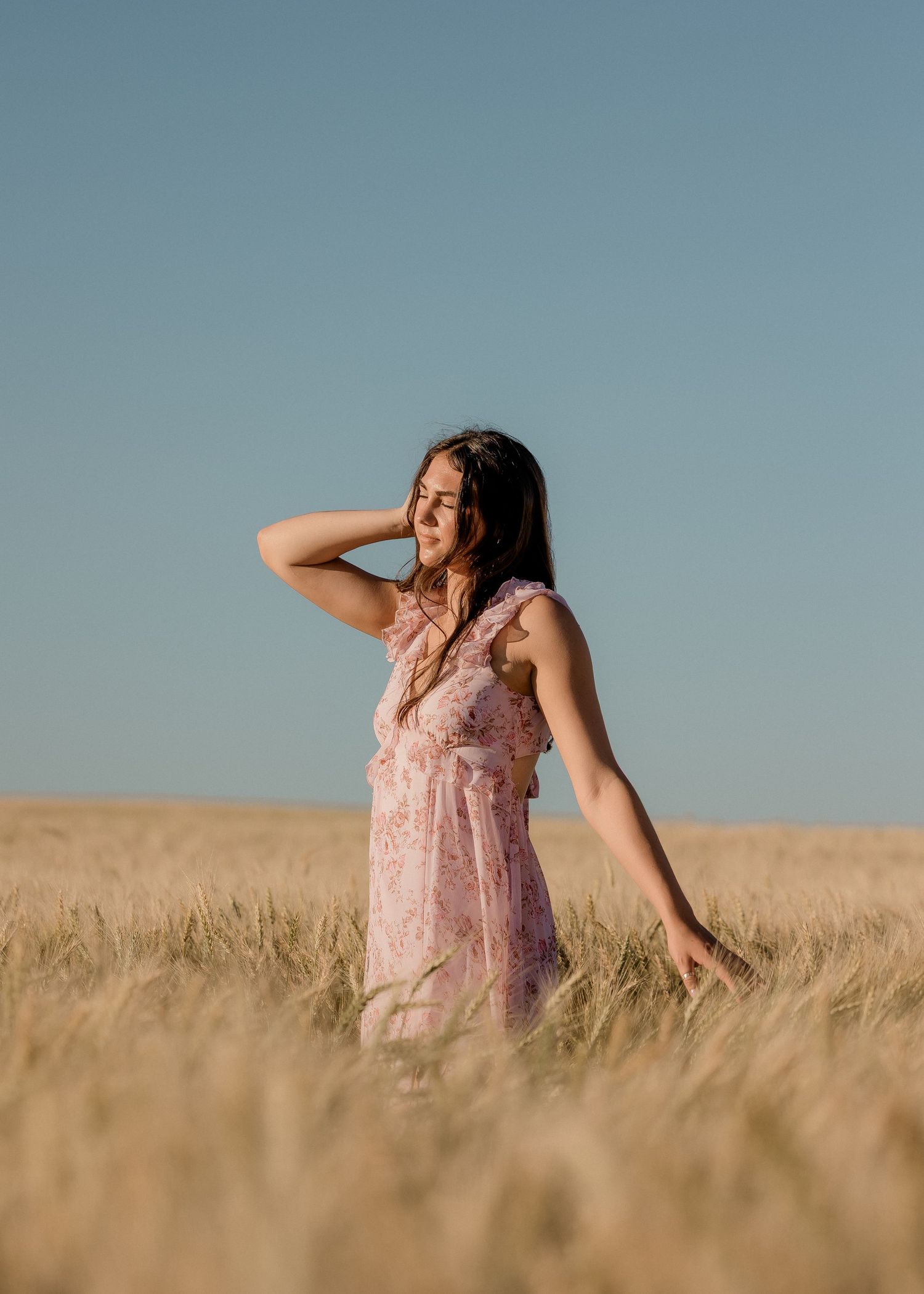 Outdoor senior portrait with soft natural light and relaxed pose