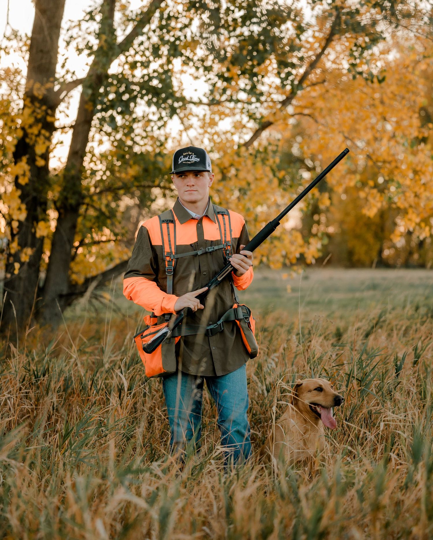 High school senior boy on family farm near Willow Lake, South Dakota with tractor and hunting gear