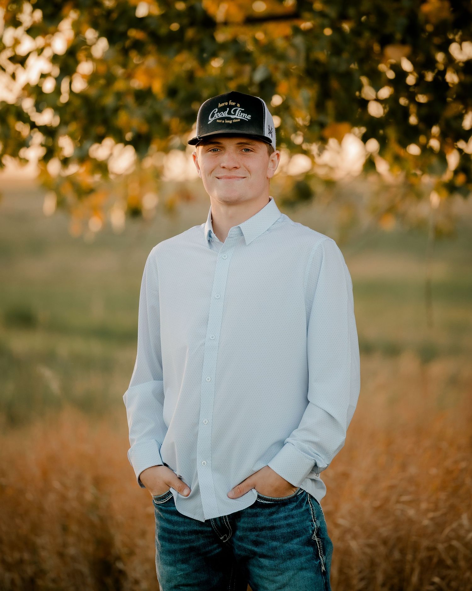 High school senior boy on family farm near Willow Lake, South Dakota with tractor and hunting gear