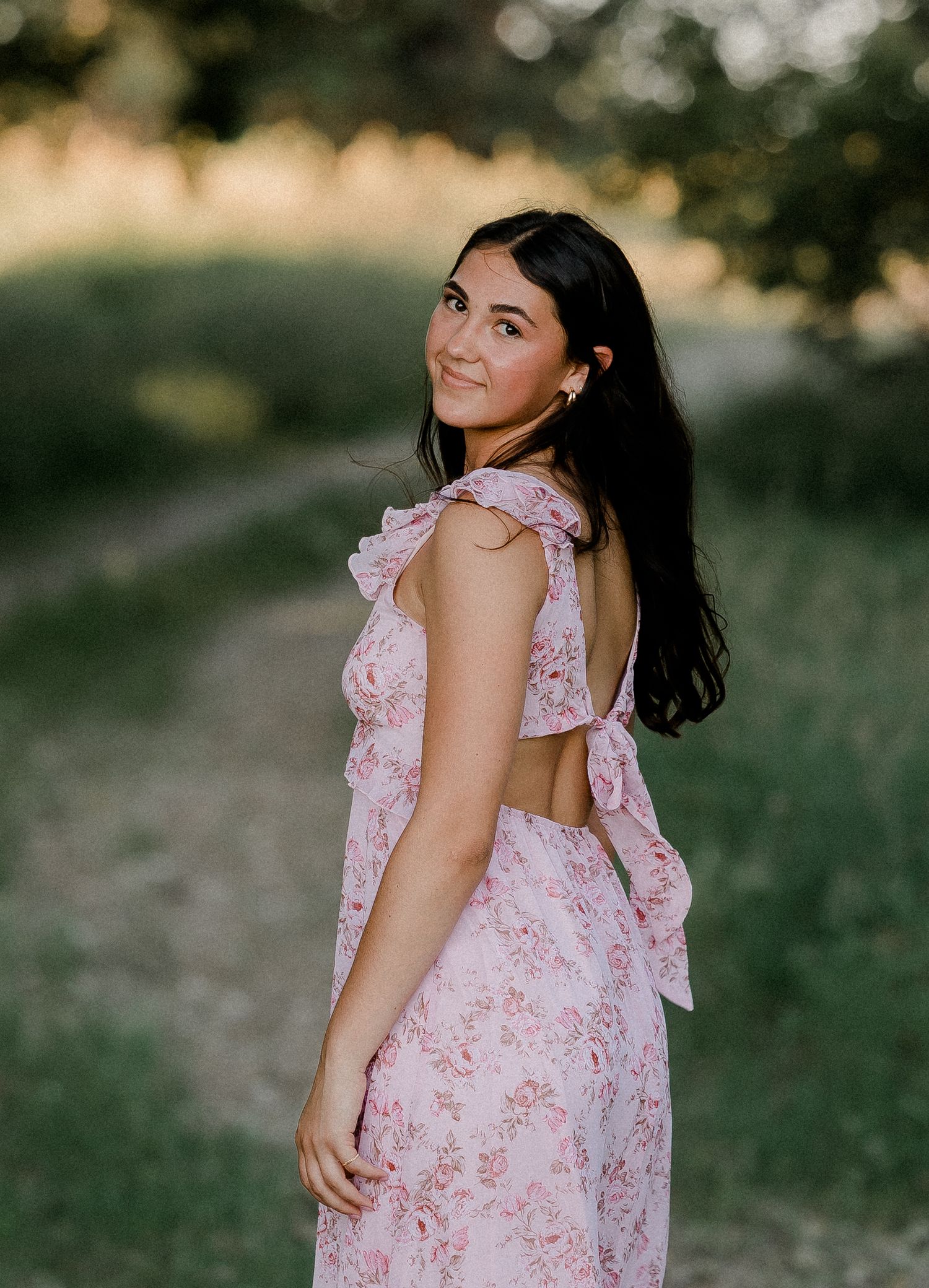 Outdoor senior portrait with soft natural light and relaxed pose