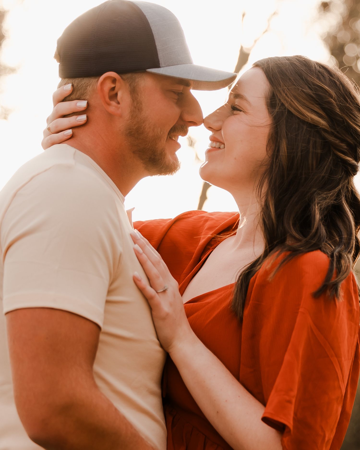 Engaged couple during fall photo session near Redfield, South Dakota with bride in red dress