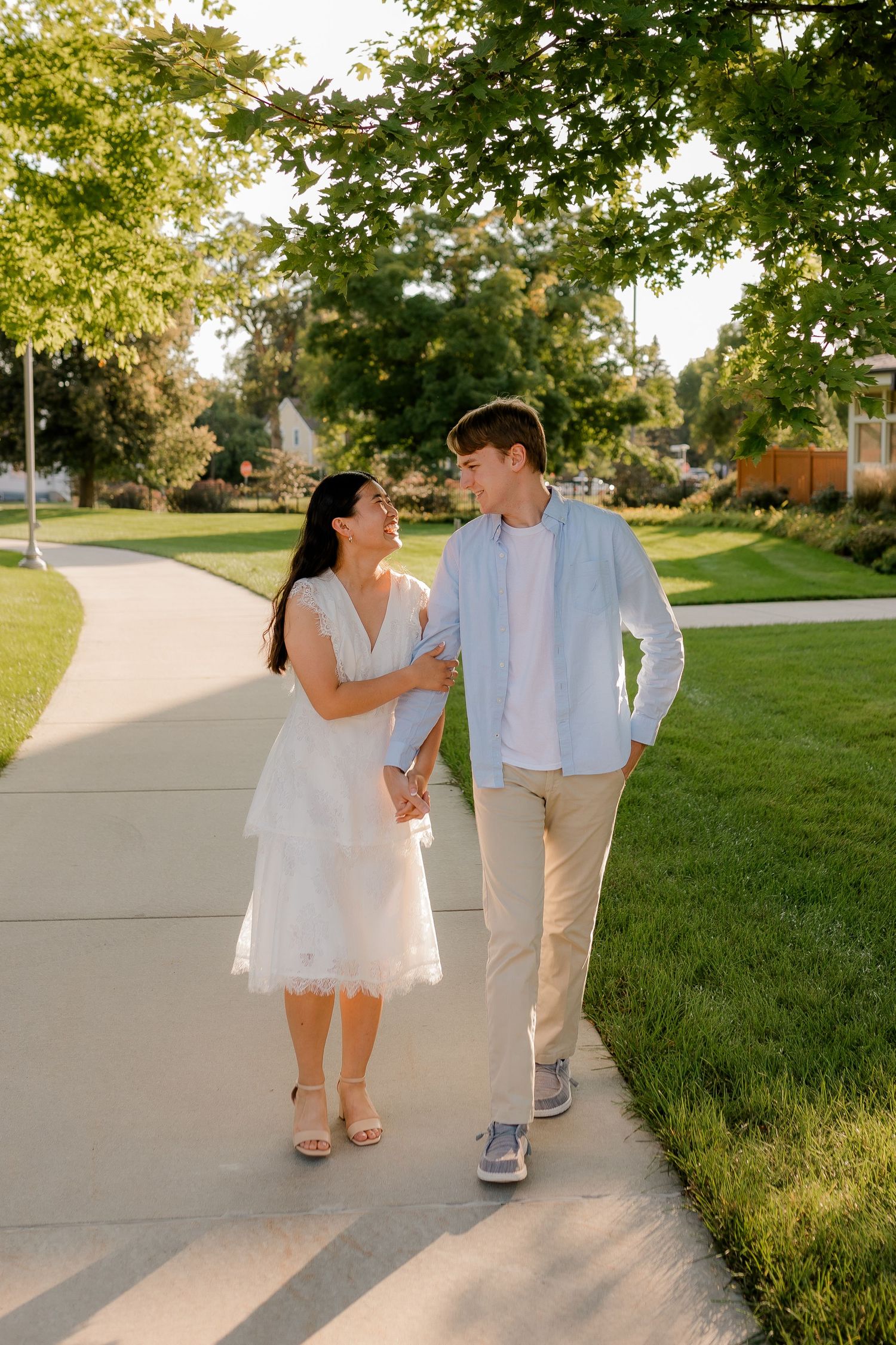 couple in the spring walking together for engagement photos in  Brookings, South Dakota