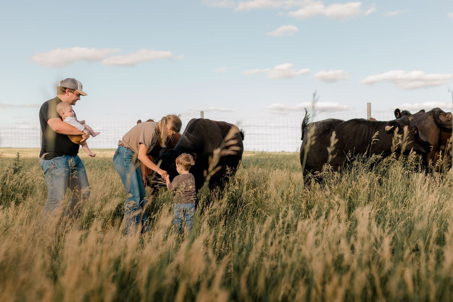 Family portrait on a working farm during lifestyle photo session in Clark County, South Dakota