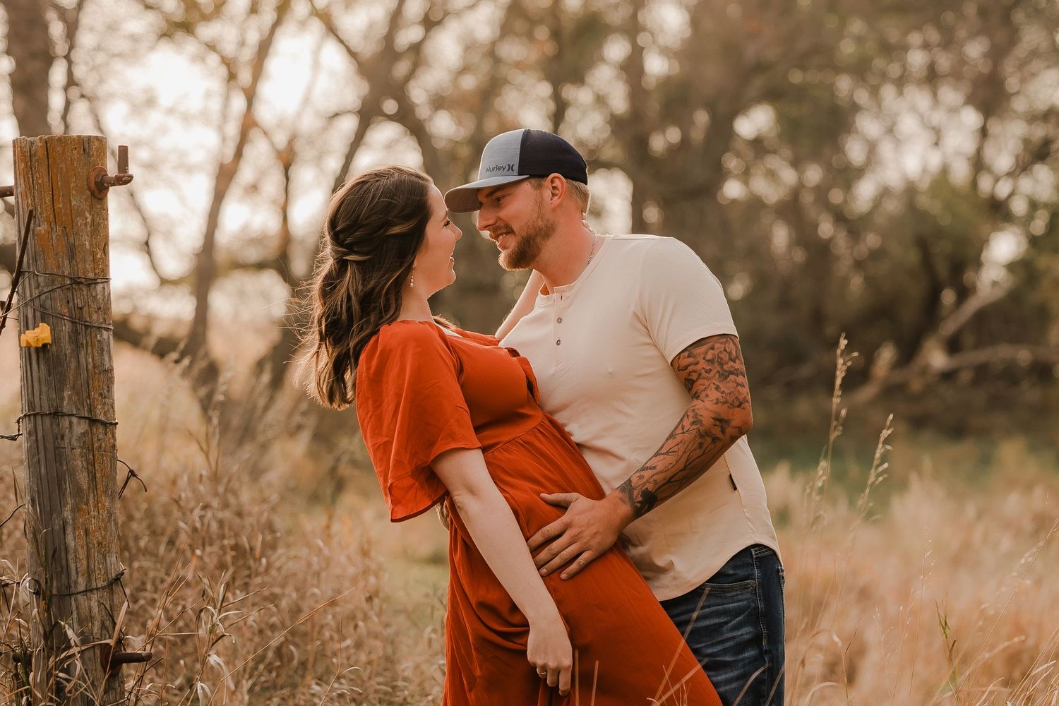 Engaged couple during fall photo session near Redfield, South Dakota with bride in red dress