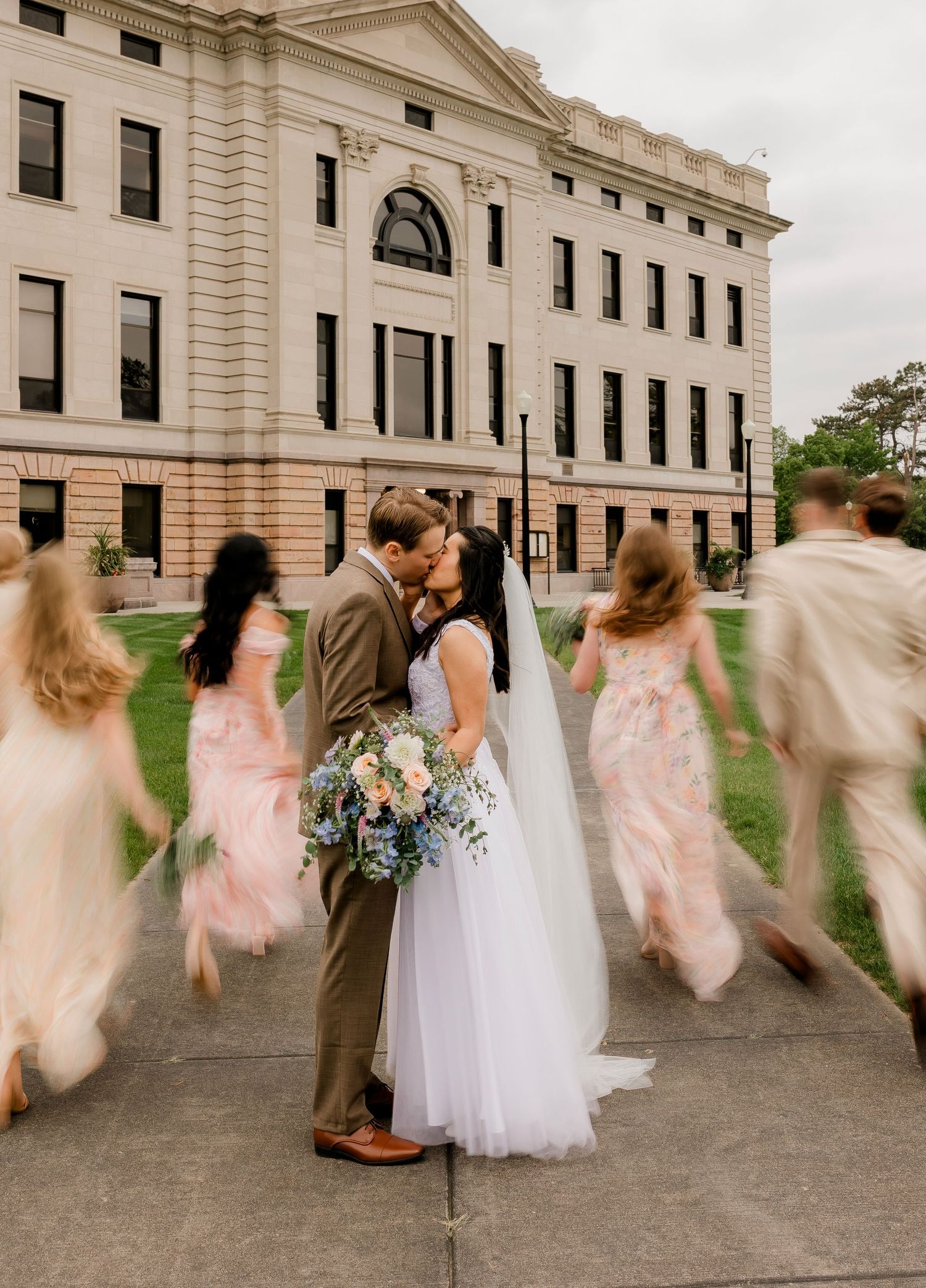 couple surrounded by bridal party outside of the capitol in Pierre, SD