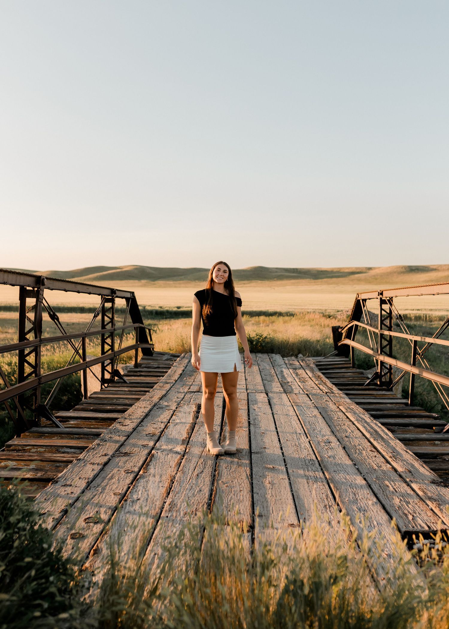 Outdoor senior portrait with soft natural light and relaxed pose