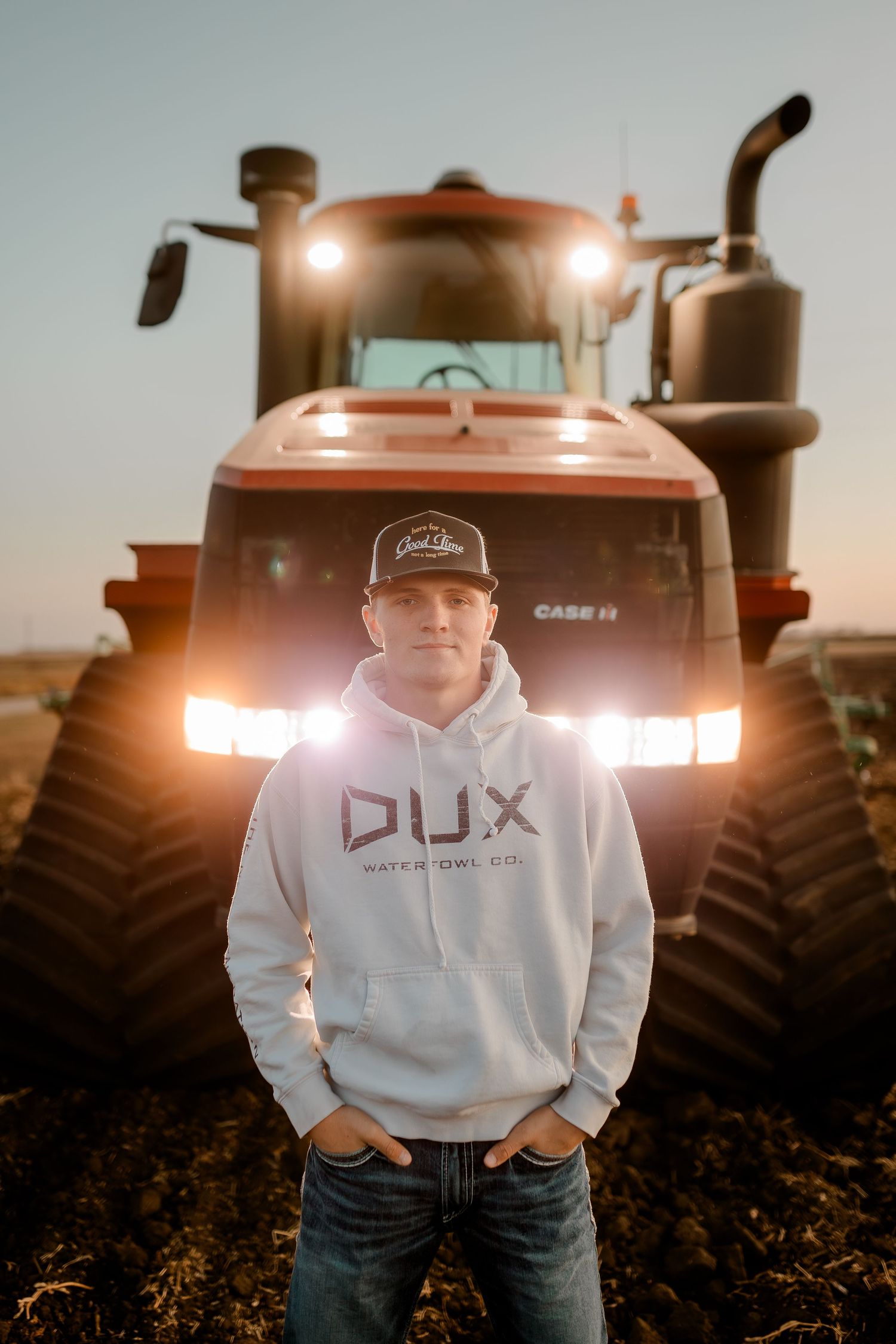 High school senior boy on family farm near Willow Lake, South Dakota with tractor and hunting gear
