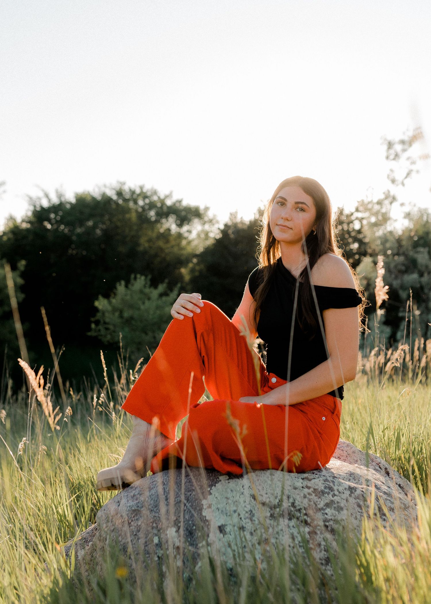 Outdoor senior portrait with soft natural light and relaxed pose