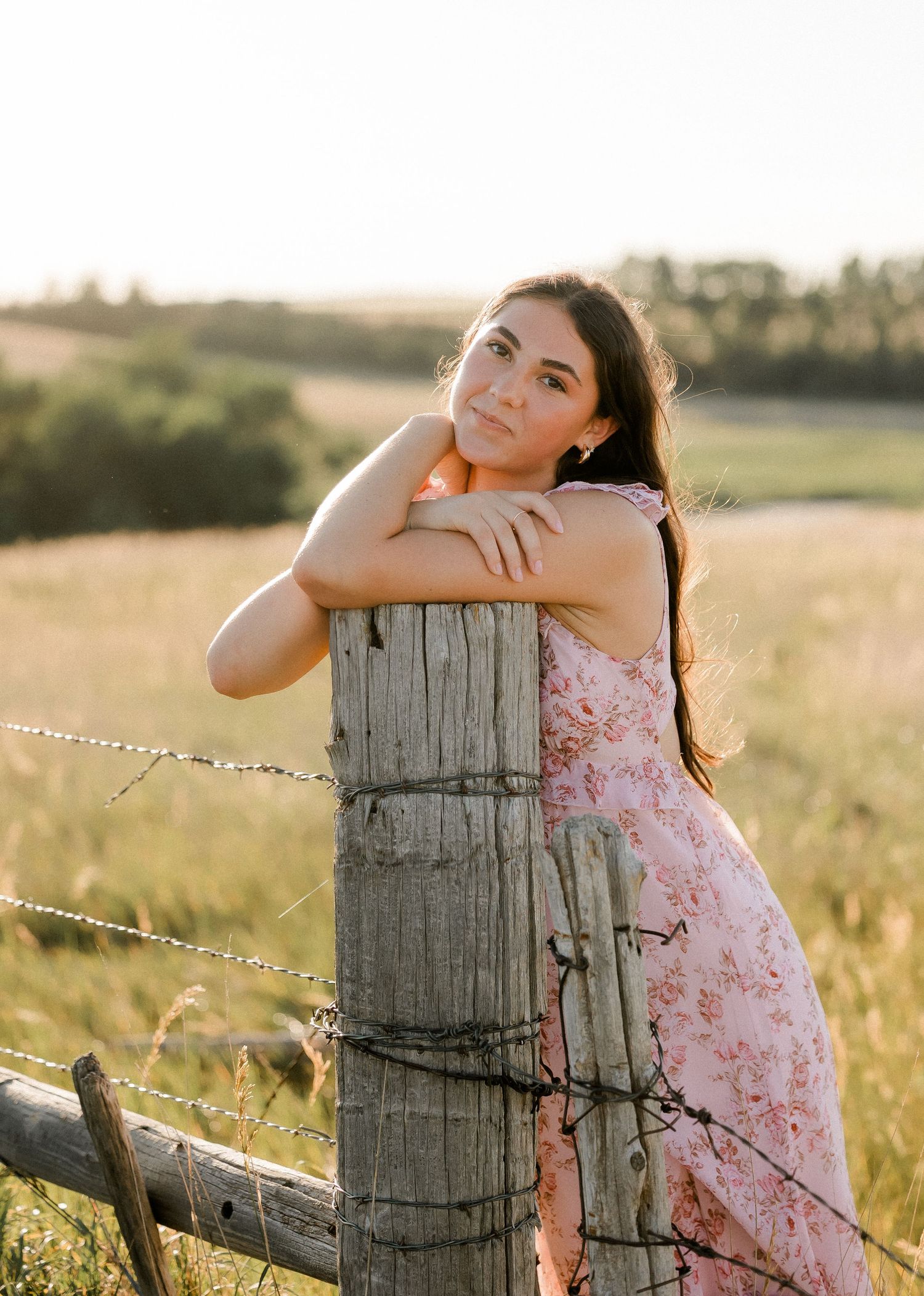 Outdoor senior portrait with soft natural light and relaxed pose