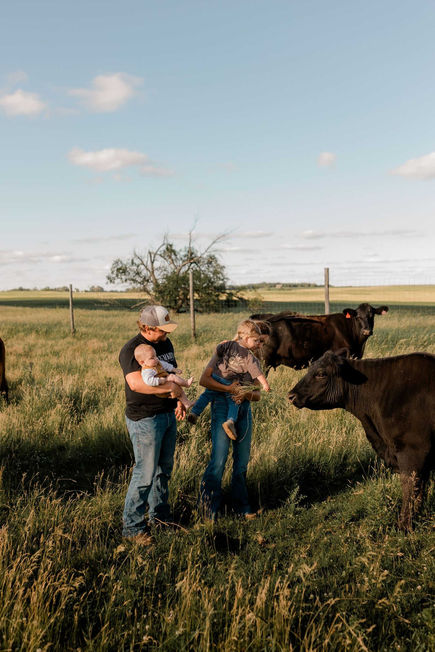 Family portrait on a working farm during lifestyle photo session in Clark County, South Dakota
