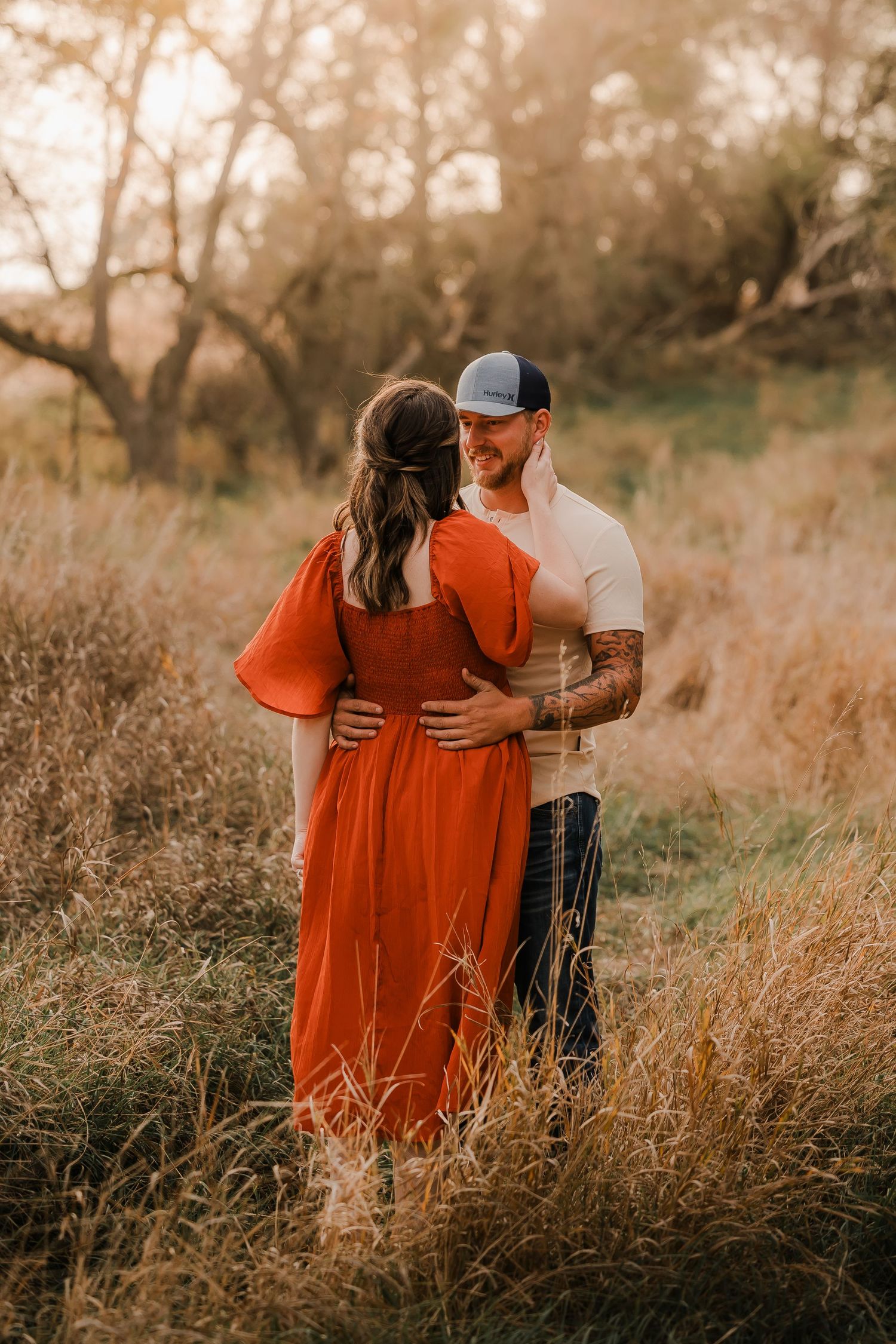 Engaged couple during fall photo session near Redfield, South Dakota with bride in red dress