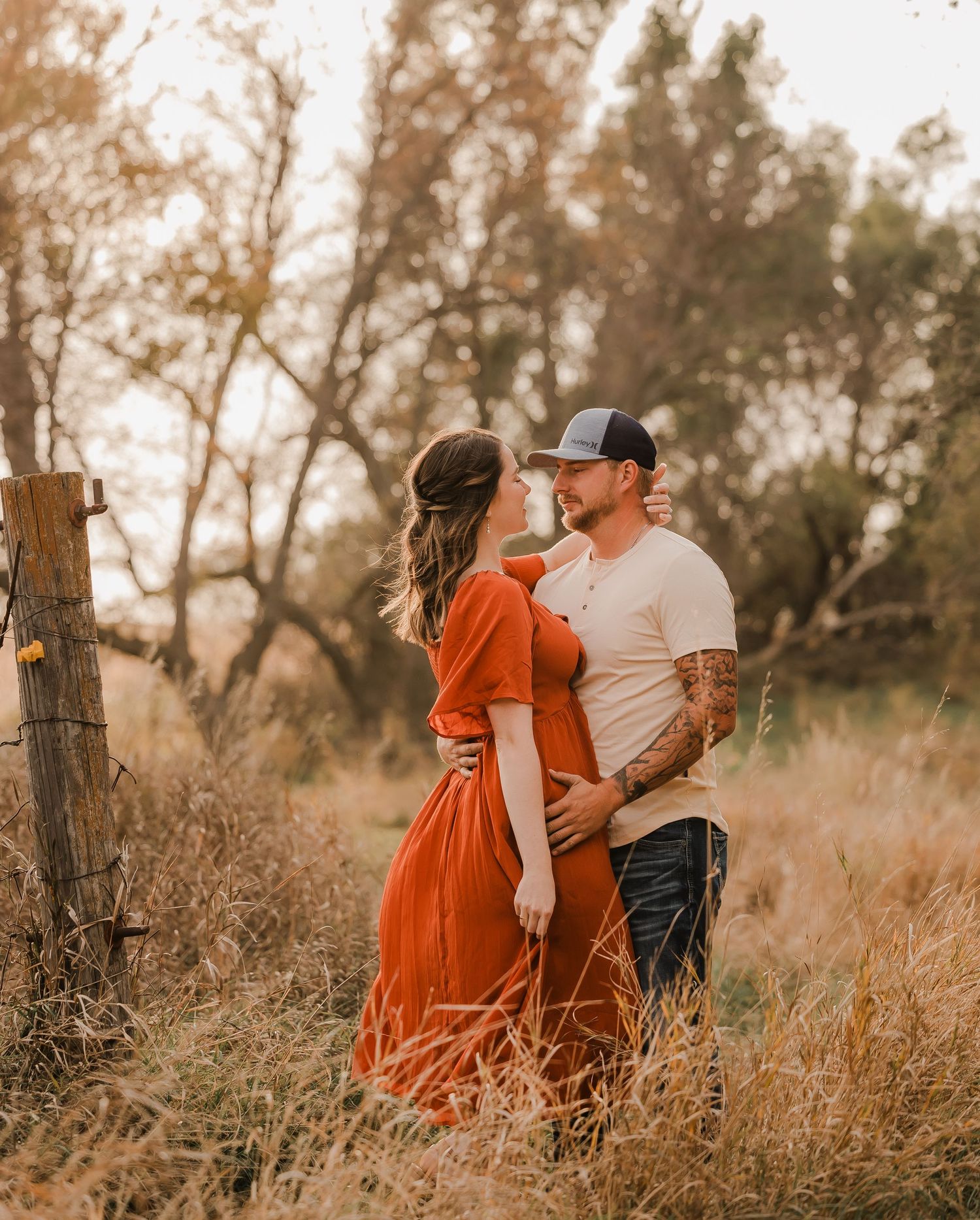 Engaged couple during fall photo session near Redfield, South Dakota with bride in red dress