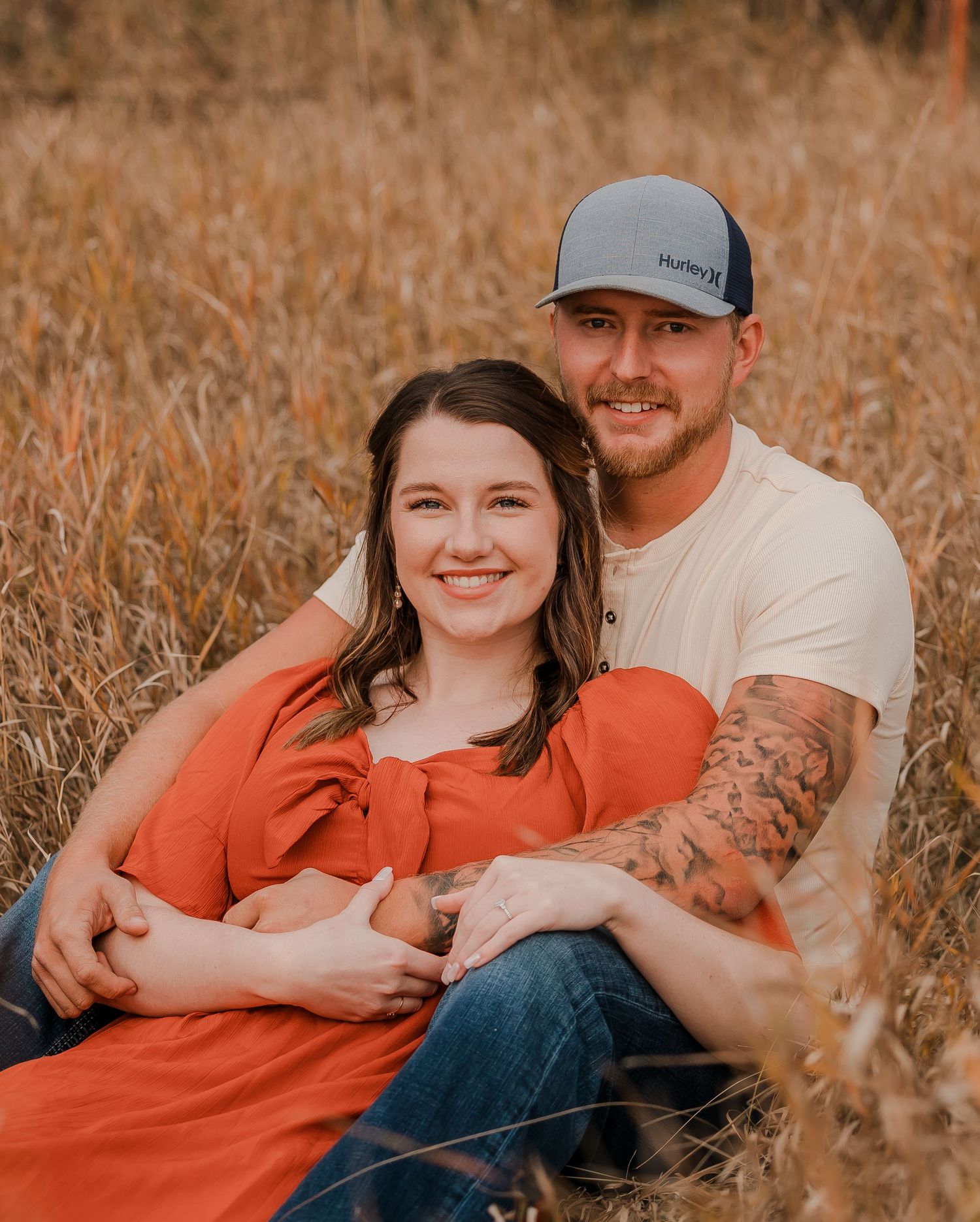 Engaged couple during fall photo session near Redfield, South Dakota with bride in red dress