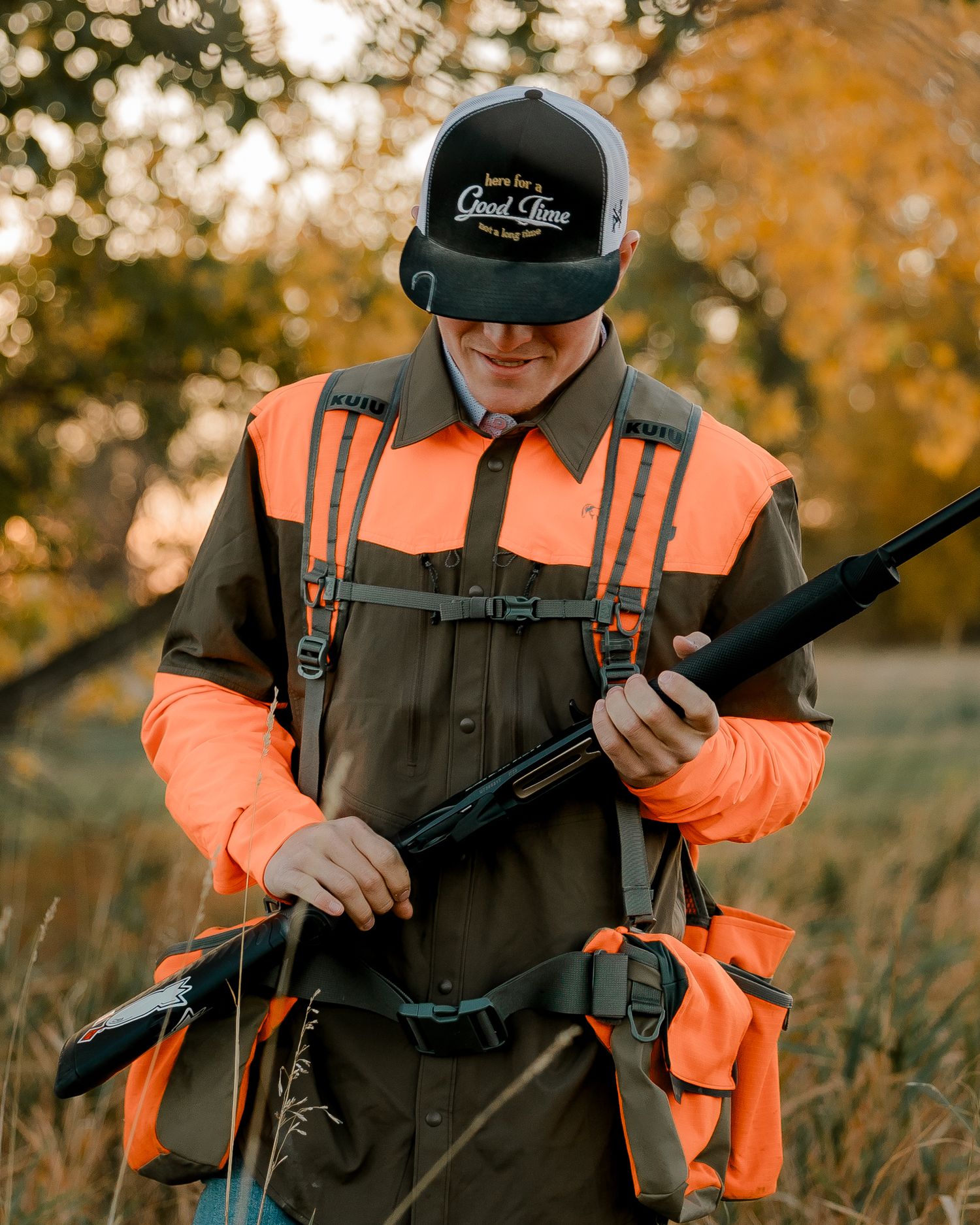 High school senior boy on family farm near Willow Lake, South Dakota with tractor and hunting gear